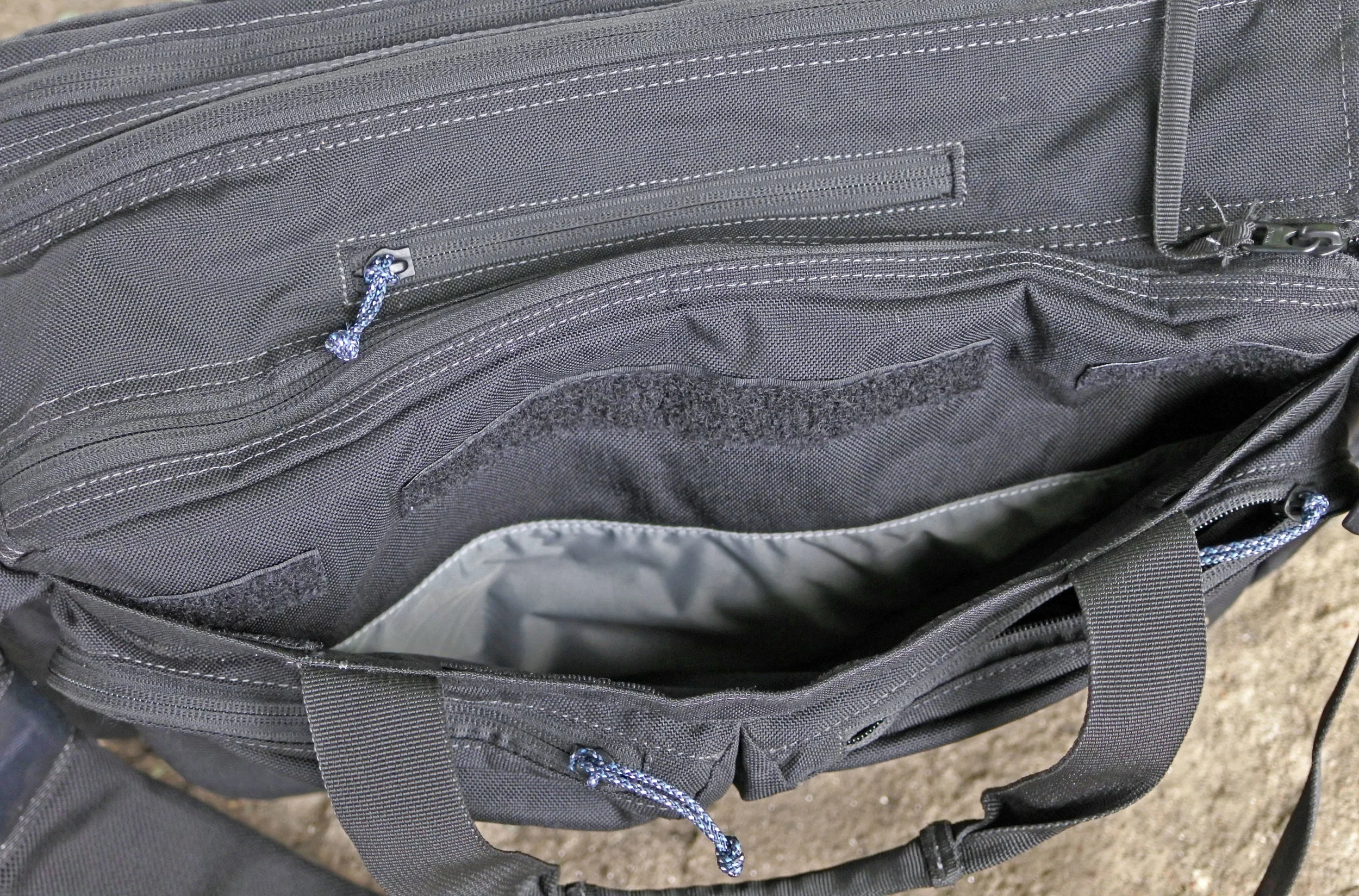 There is a hidden pocket on the front of the bag, under the admin pockets. 