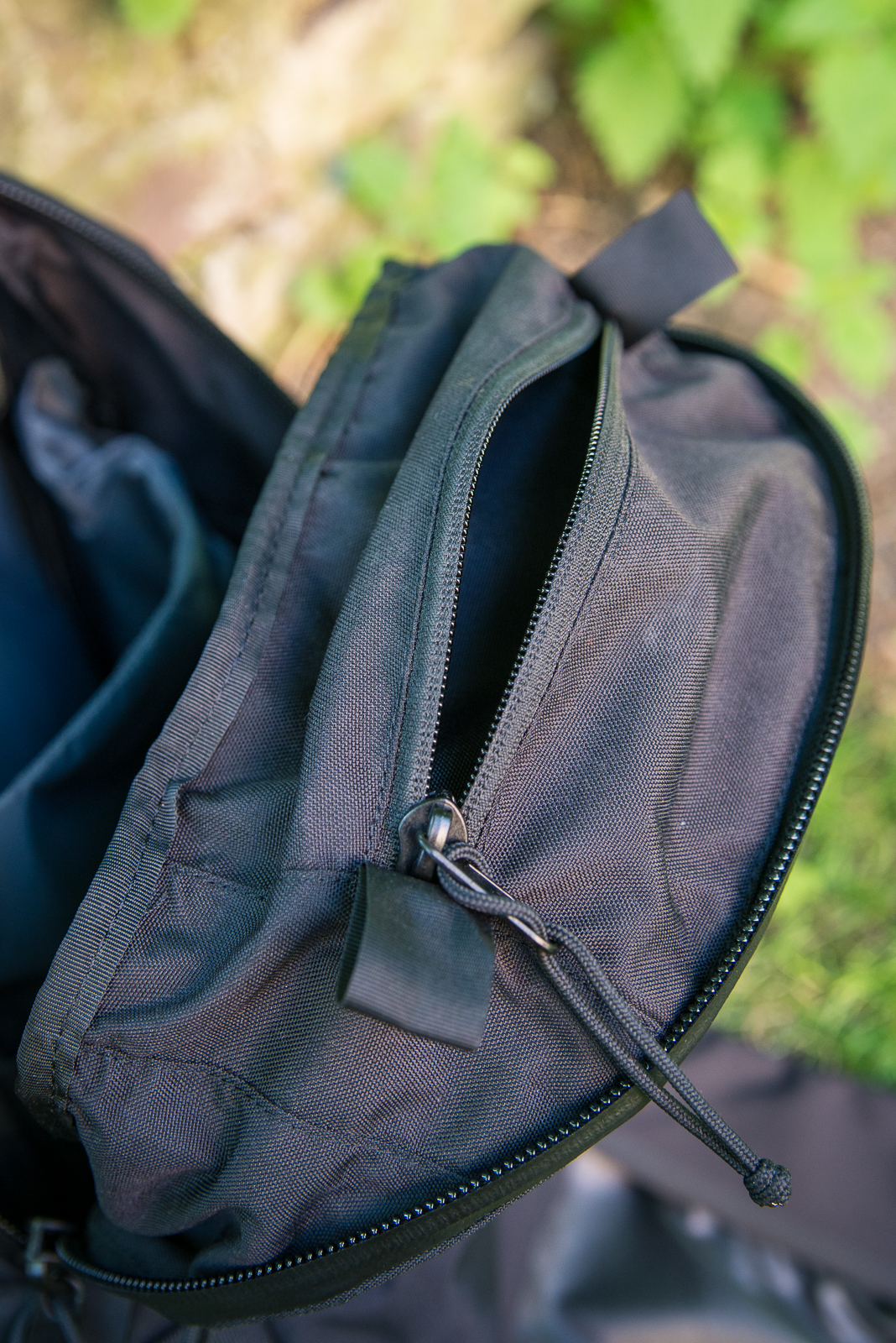 A little triangular pouch sits at the top under the main zipper - a great spot for a glasses case or compact camera. 