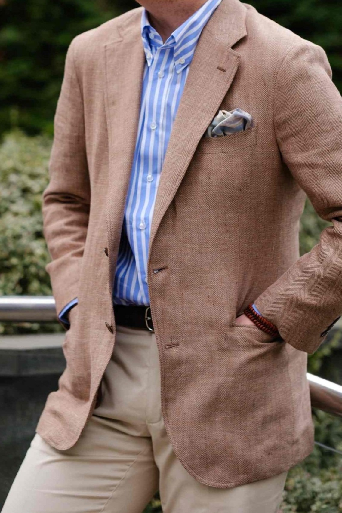 Man in brown jacket with striped shirt