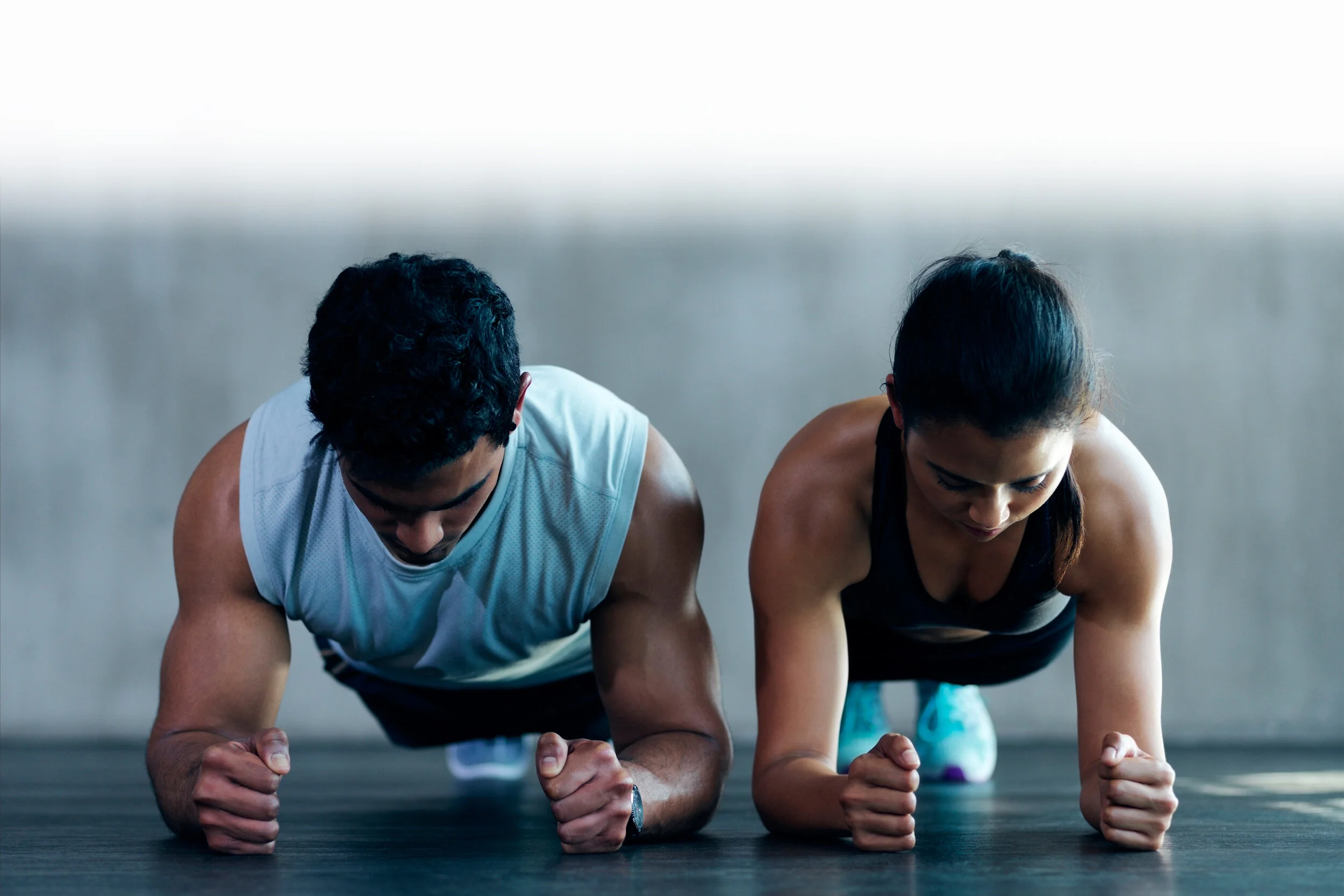 A man and a woman performing planks side-by-side.jpg