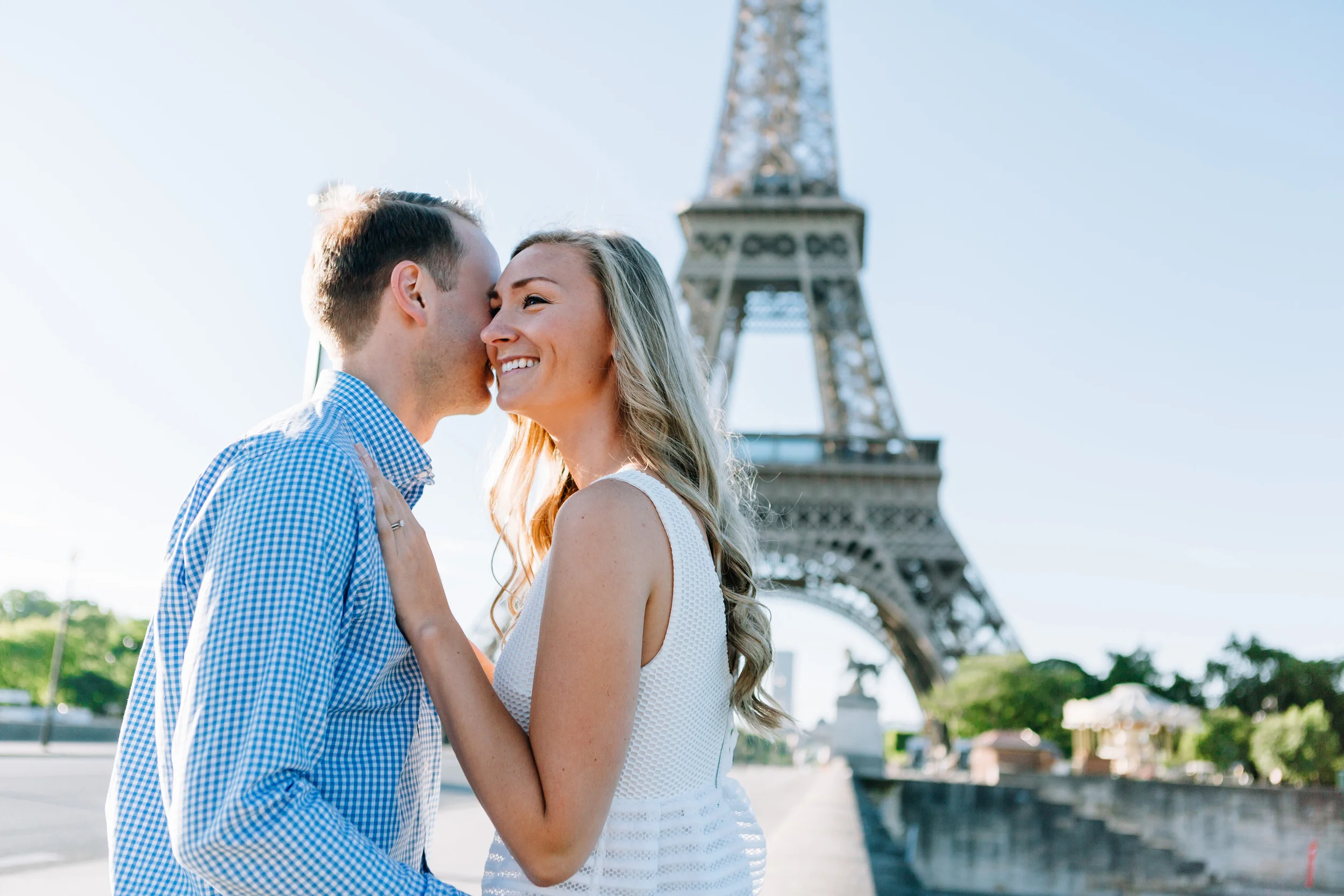 paris photographer couple smiling and kissing by the eiffel tower