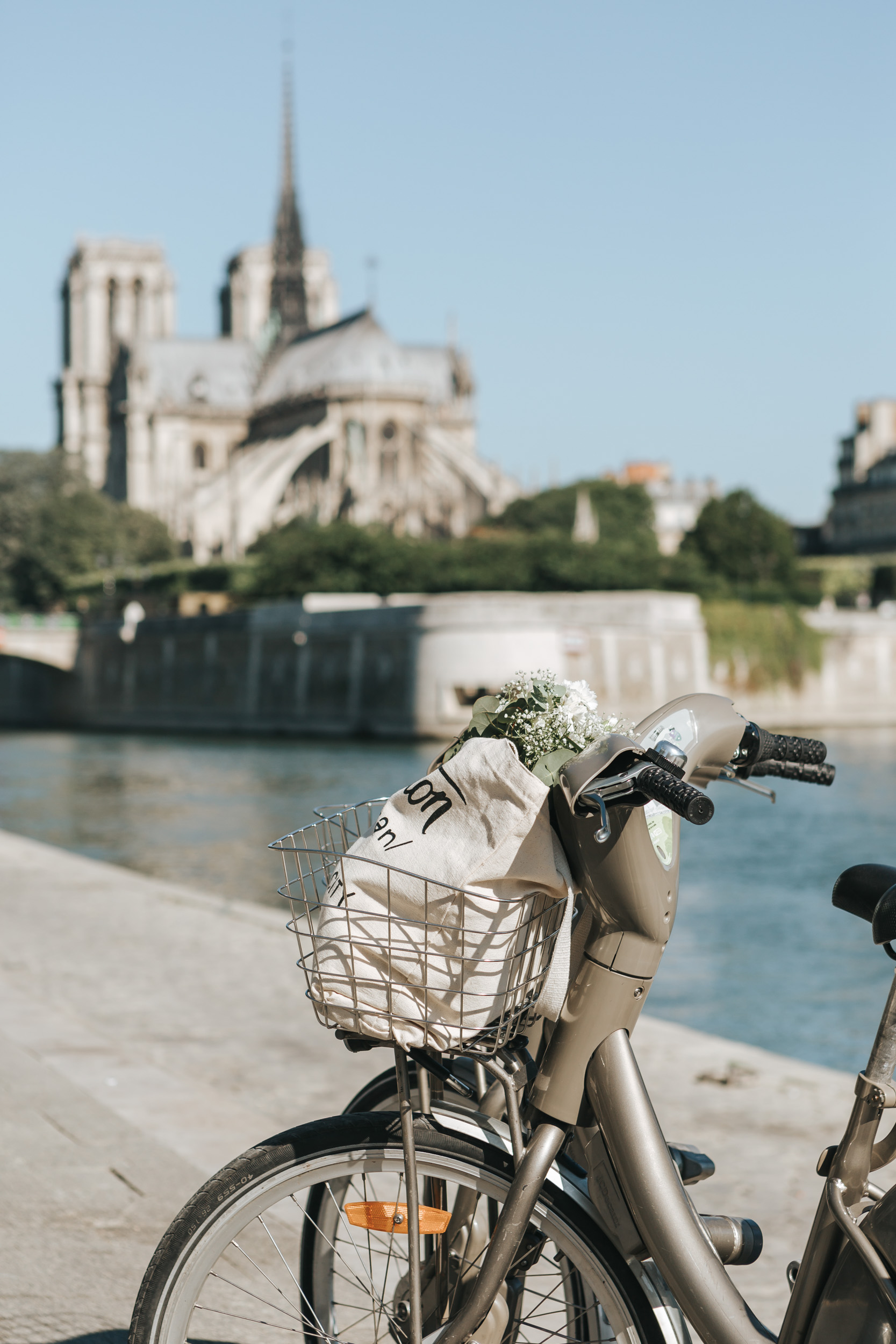 Photographer in Paris Quai Seine Velib bicycle Notre Dame