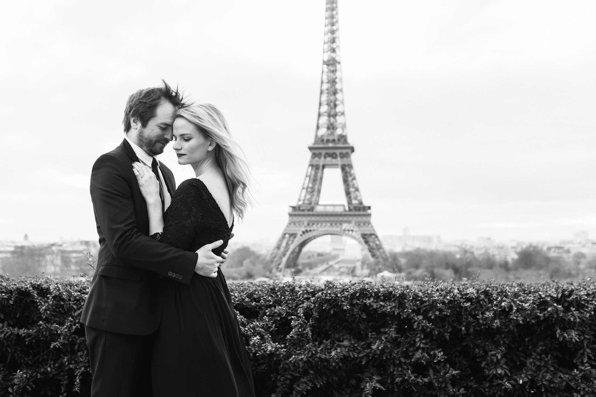 Paris engagement couple portrait in black and white by the Eiffel Tower captured by Paris Photographer Federico Guendel