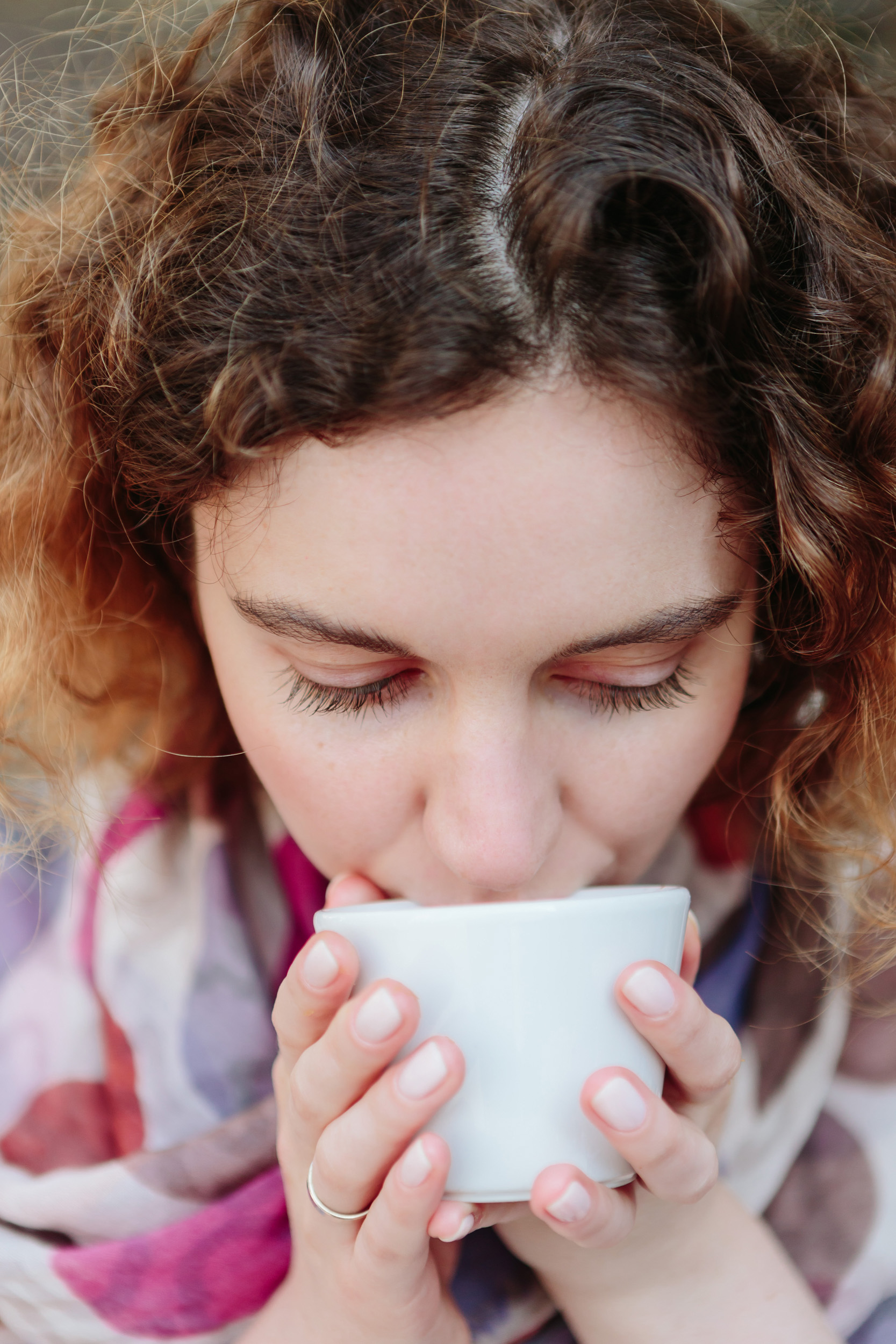 Close up portrait of a girl drinking coffee at a cafe captured by Paris Photographer Federico Guendel IheartParisFr