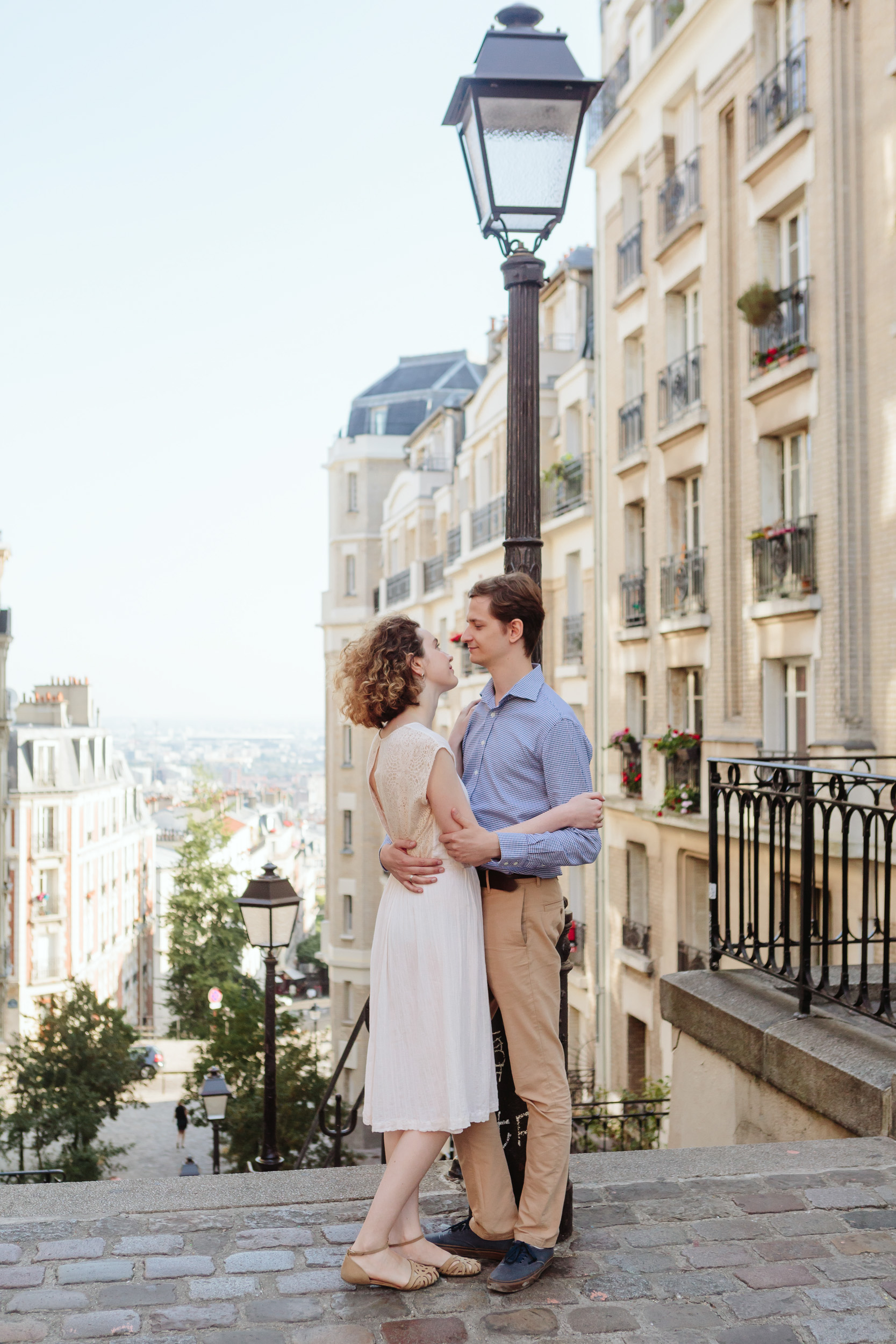 Couple in love holding each other on the street of Montmartre captured by Paris Photographer Federico Guendel IheartParisFr