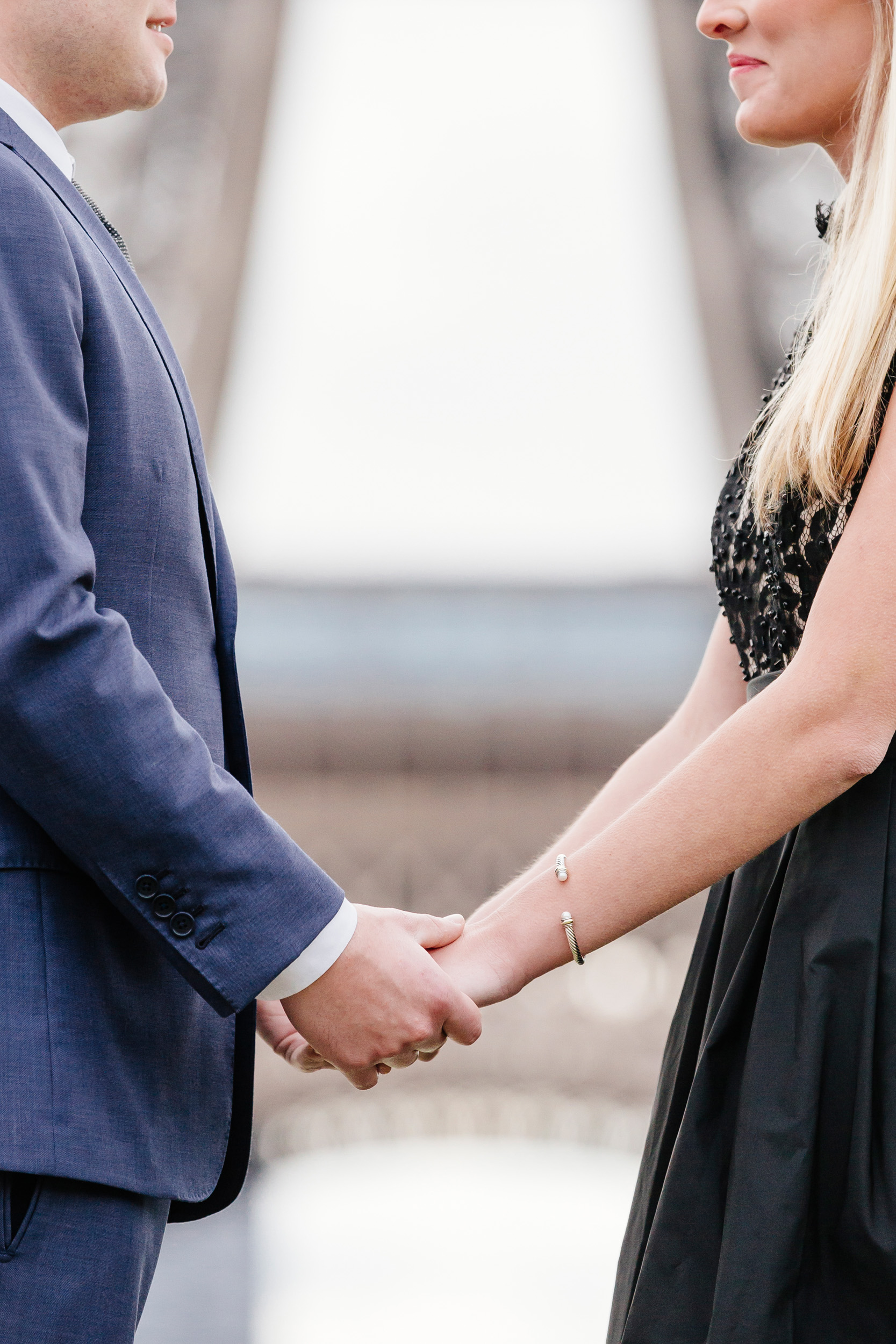 Details of a couple holding hands in front of the Eiffel Tower captured by Paris Photographer Federico Guendel www.iheartparis.fr