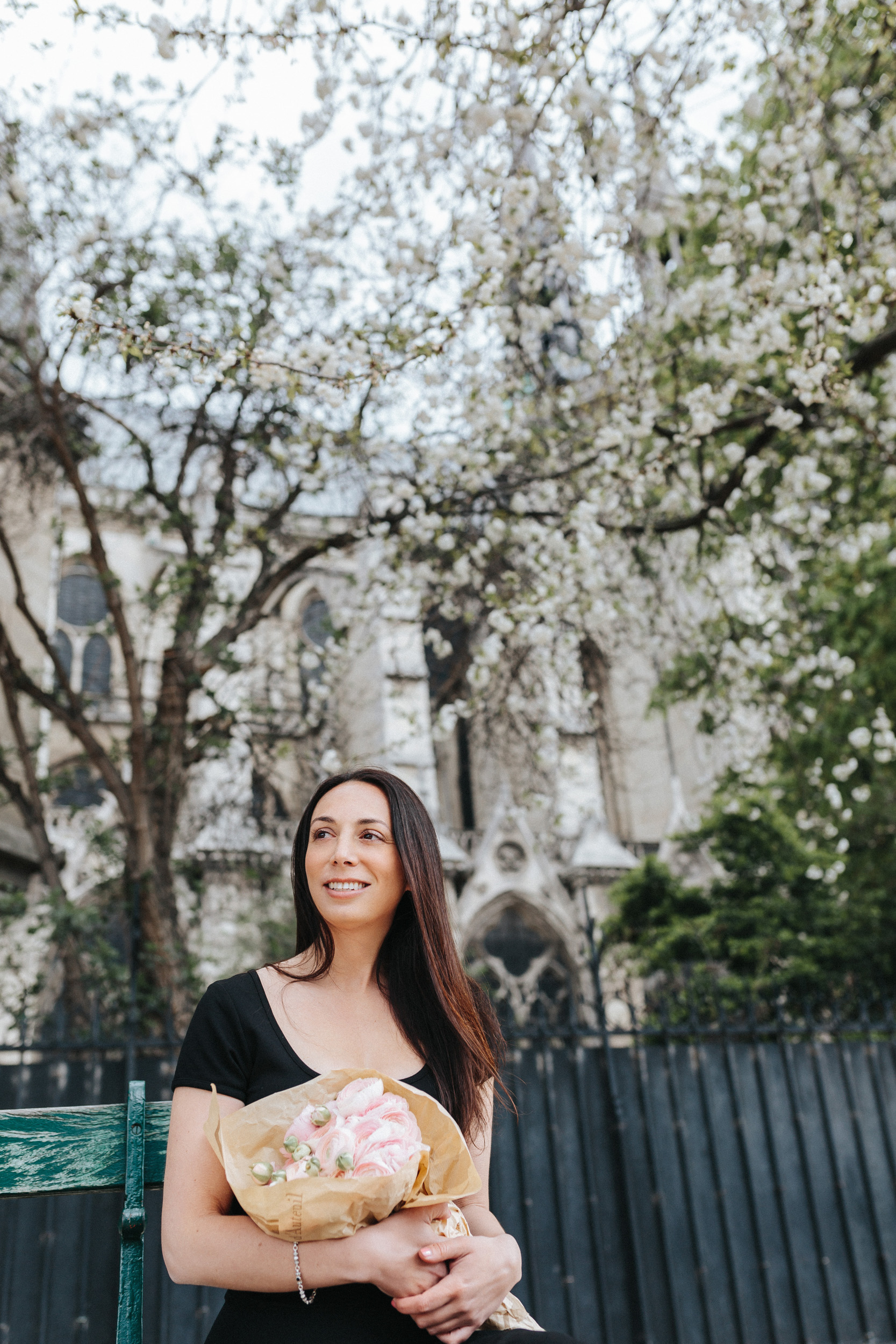 Spring portrait of Rebecca Plotnick founder of Every Day Parisian blog in front of Notre Dame and blossoms captured by Paris Photographer Federico and Anastasia Guendel IheartParisFr TheFlyingPoodle