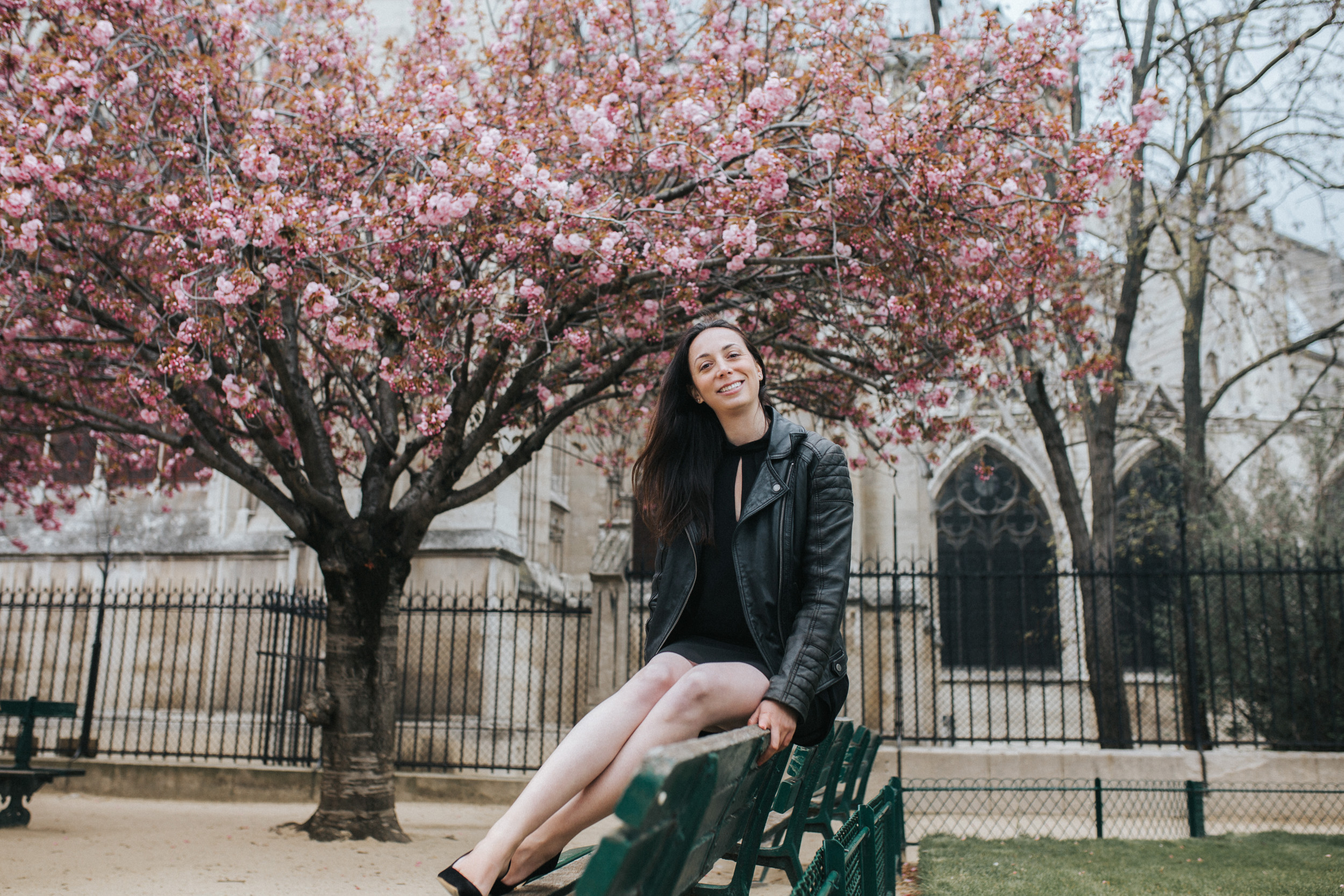 Spring portrait of Rebecca Plotnick founder of Every Day Parisian blog in front of Notre Dame and cherry blossoms captured by Paris Photographer Federico and Anastasia Guendel IheartParisFr TheFlyingPoodle