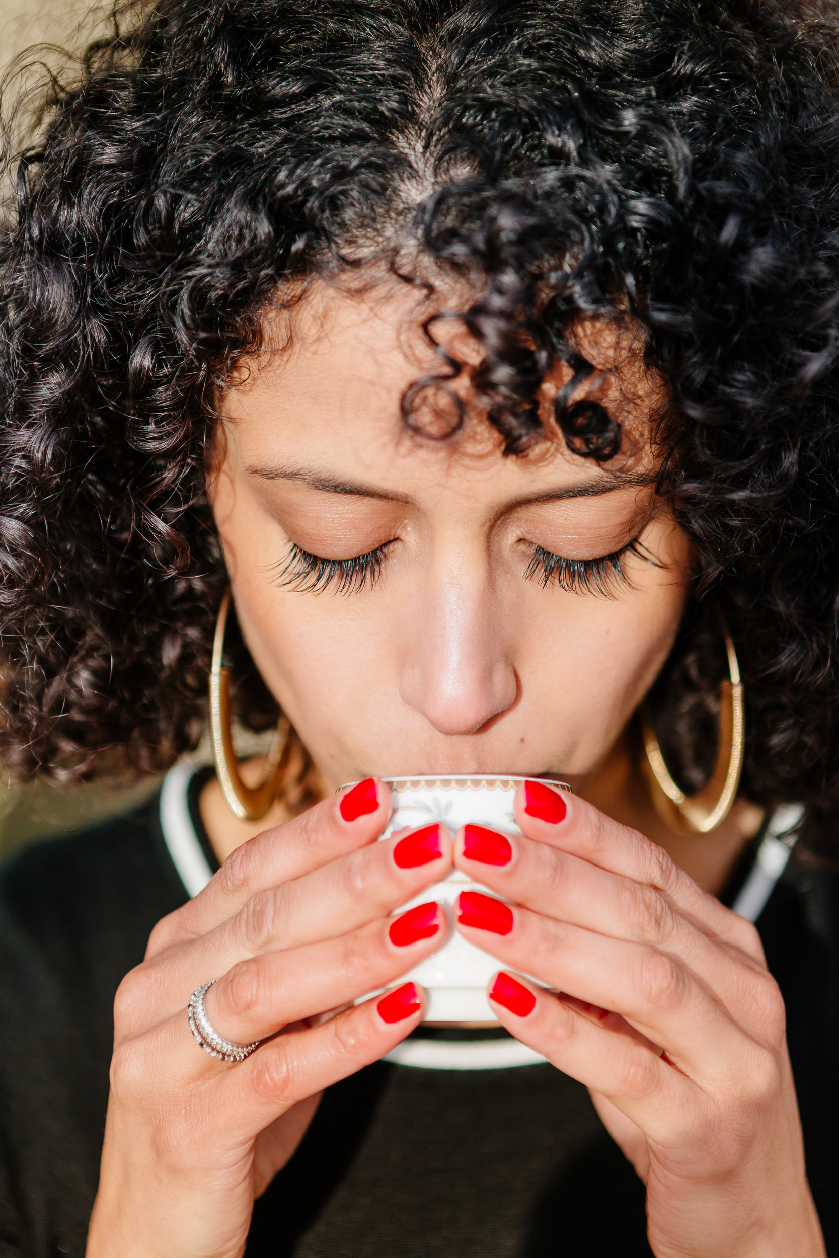 Close up portrait of a girl drinking coffee captured by Paris Photographer Federico Guendel IheartParis www.iheartparis.fr