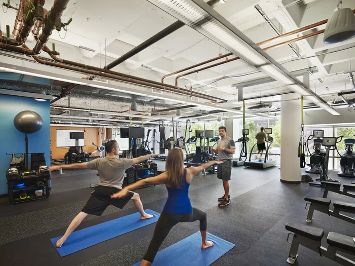 Employees at Google’s Cambridge Office in Boston take a yoga break in the company’s fitness center. Photo from Office Snapshots .