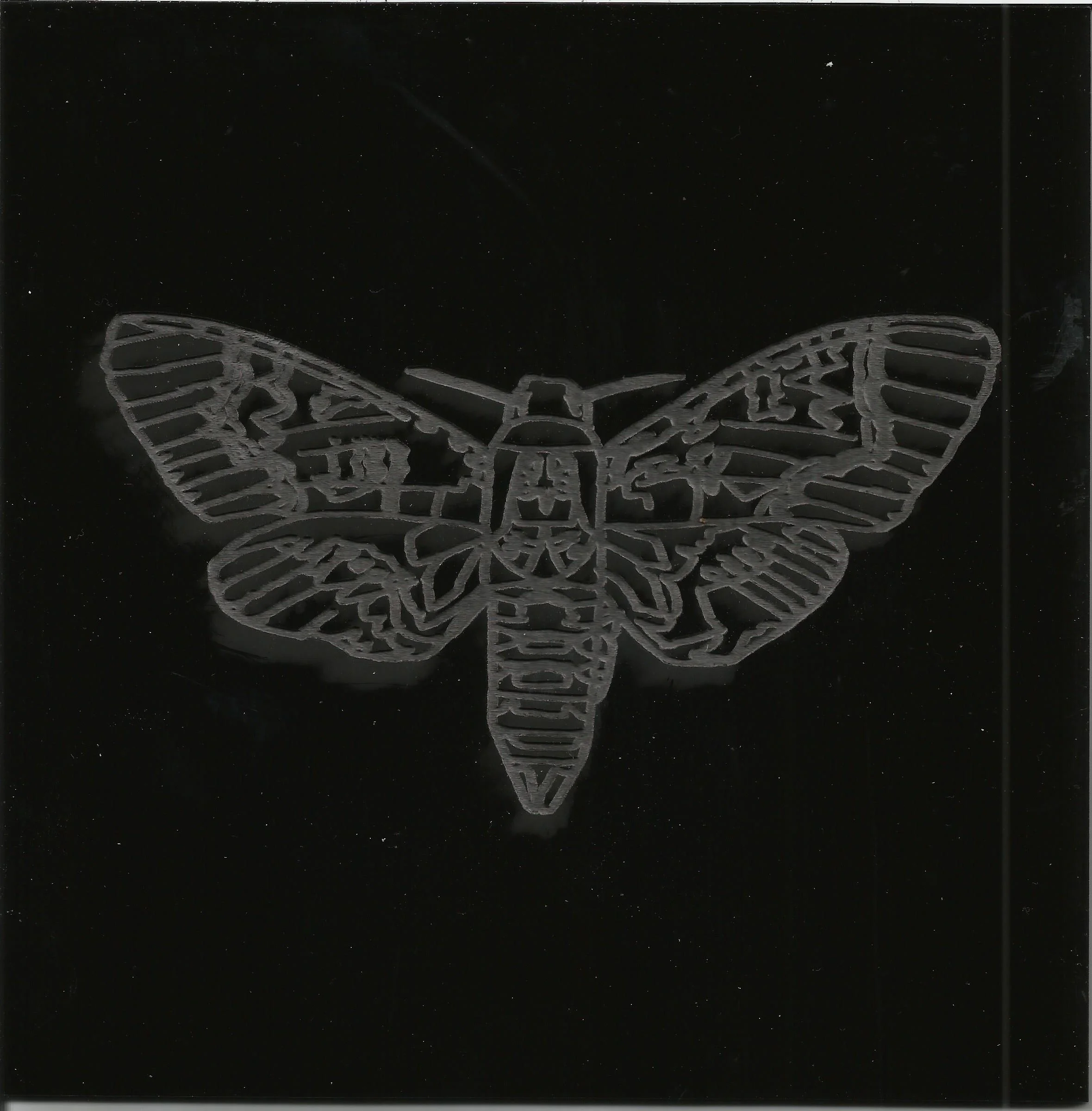 Laser etched into black plastic