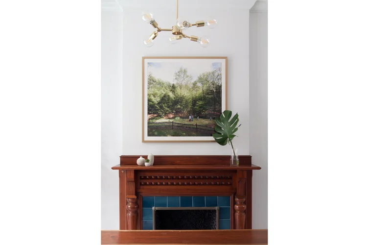 Originally the plan was to strip or paint the wood on the fireplace, but after installation of the new tile surround, we all agreed the warm wood was a beautiful counterpoint to the blue.