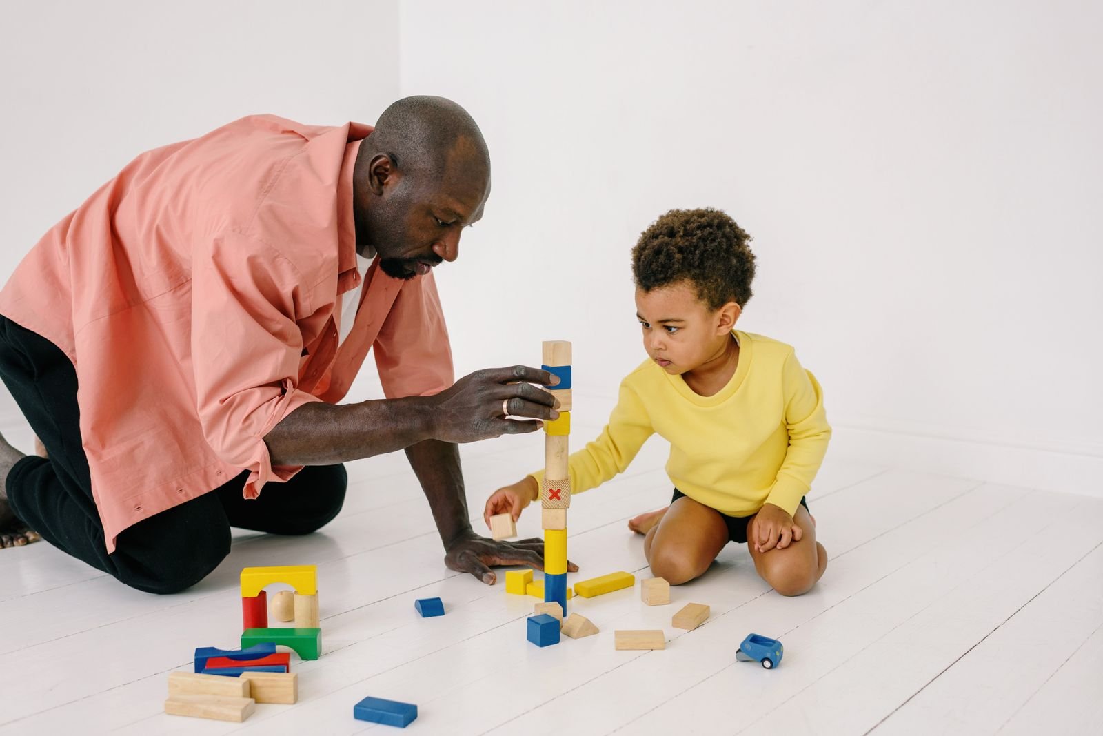 Father and son playing with wooden blocks together