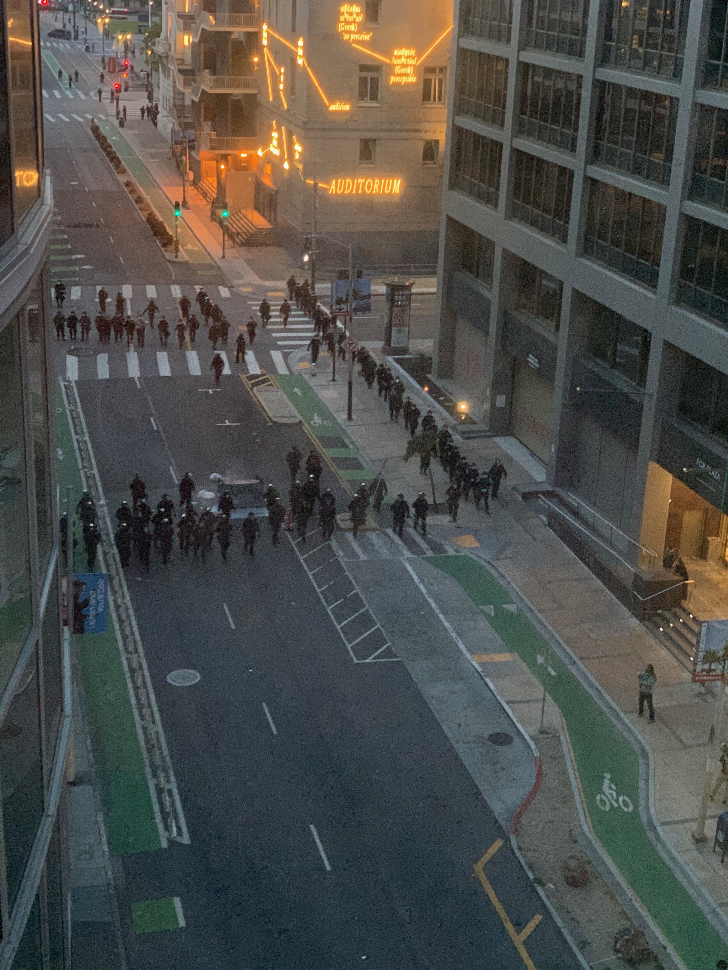  Police moving in after protestors had set fire to a dumpster and flipped it over in the middle of Polk St. The police had been stationary around City Hall imposing curfew  until the fire was set off.  June 31, 2020 