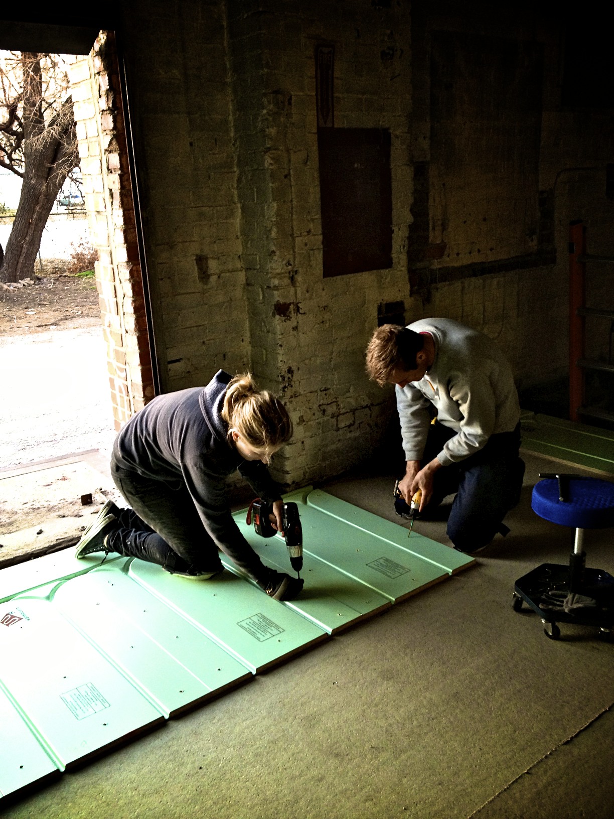 Callie and Jeremy install the first few Warmboard-R panels into their new home.