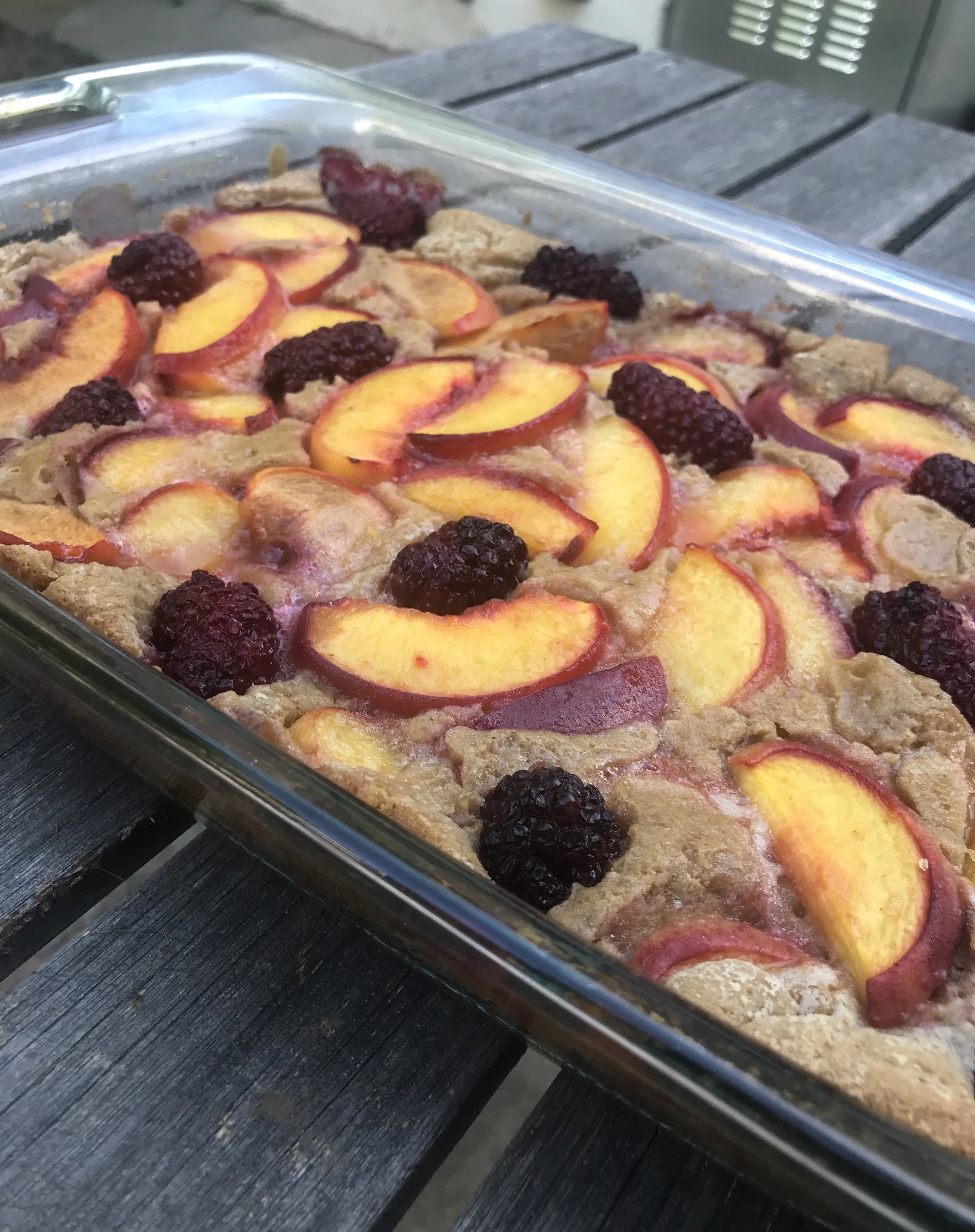 Homemade vegan peach and blackberry cobbler baked until golden