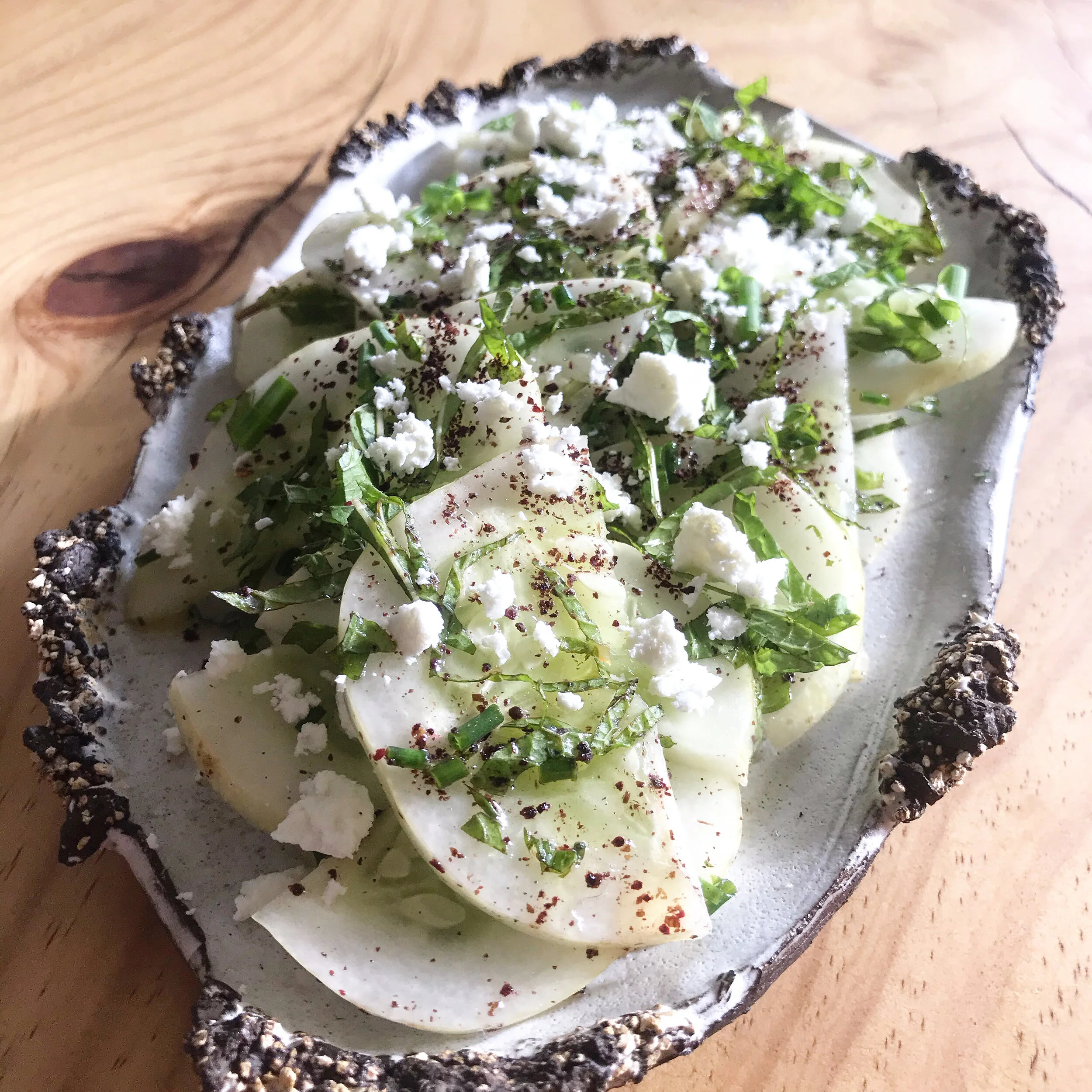 Fresh lemon cucumber salad with herbs and dressing