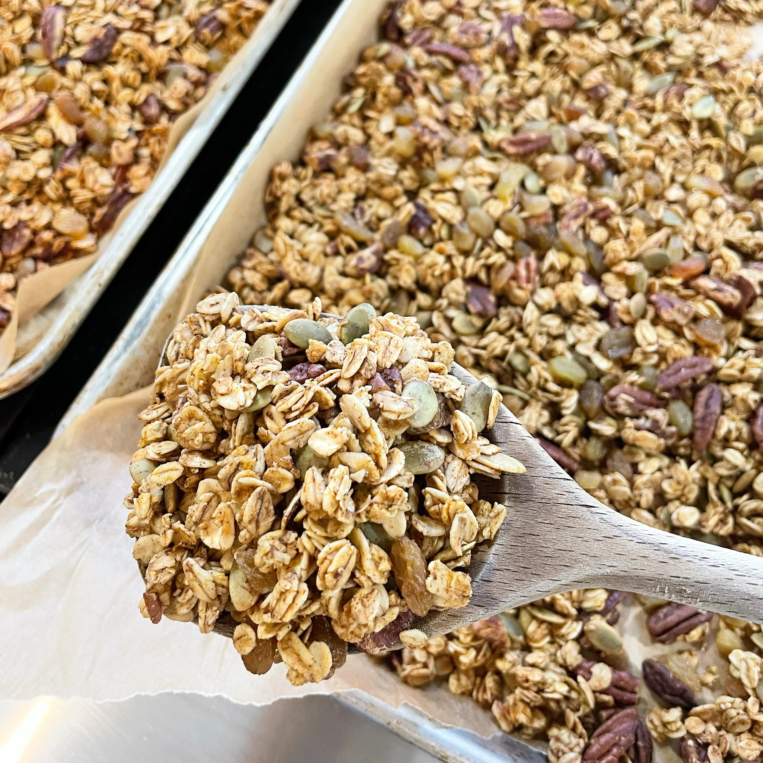 Homemade pumpkin granola spread on a baking sheet