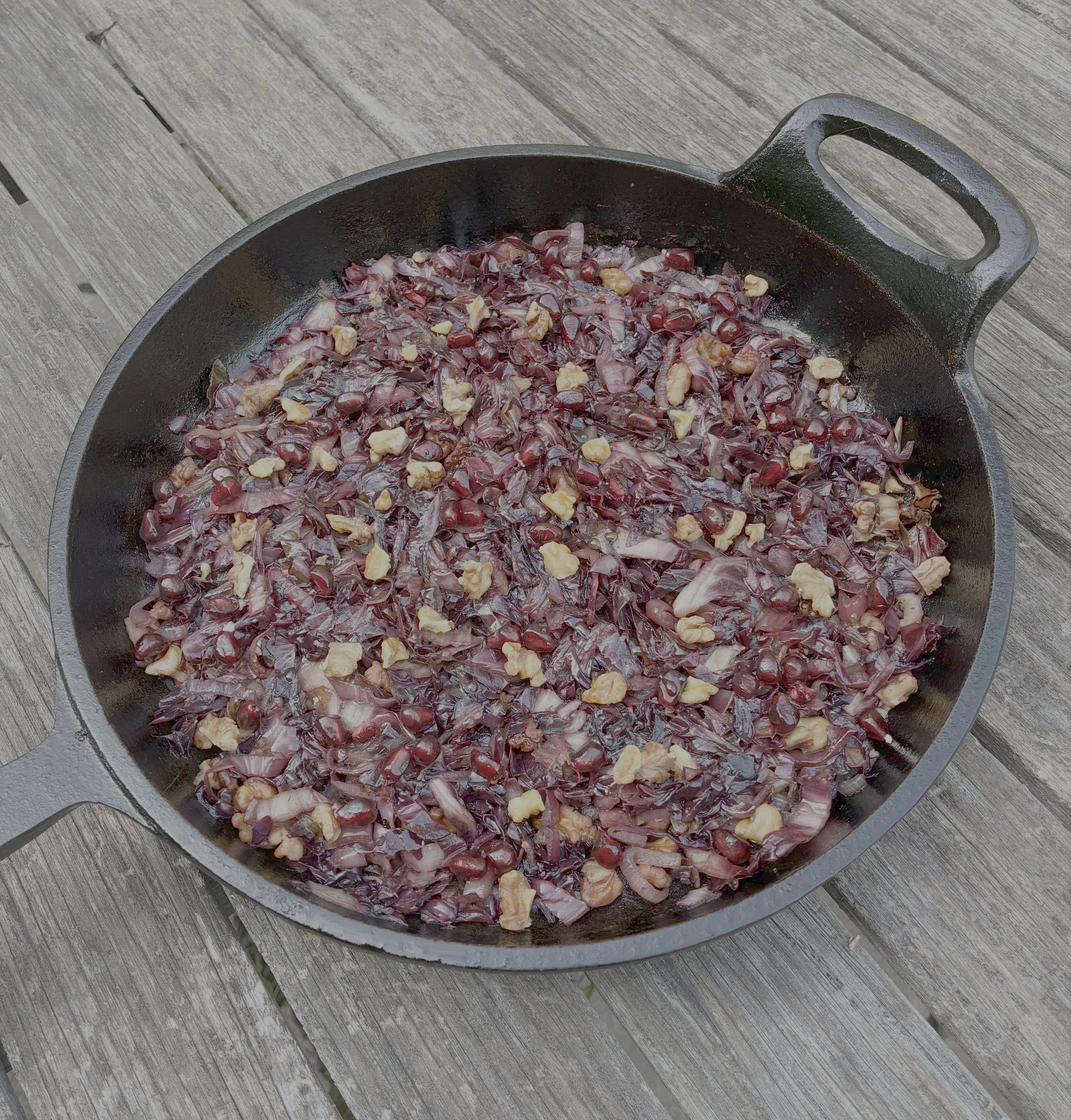 Sautéed radicchio with balsamic vinegar and toasted walnuts in a skillet