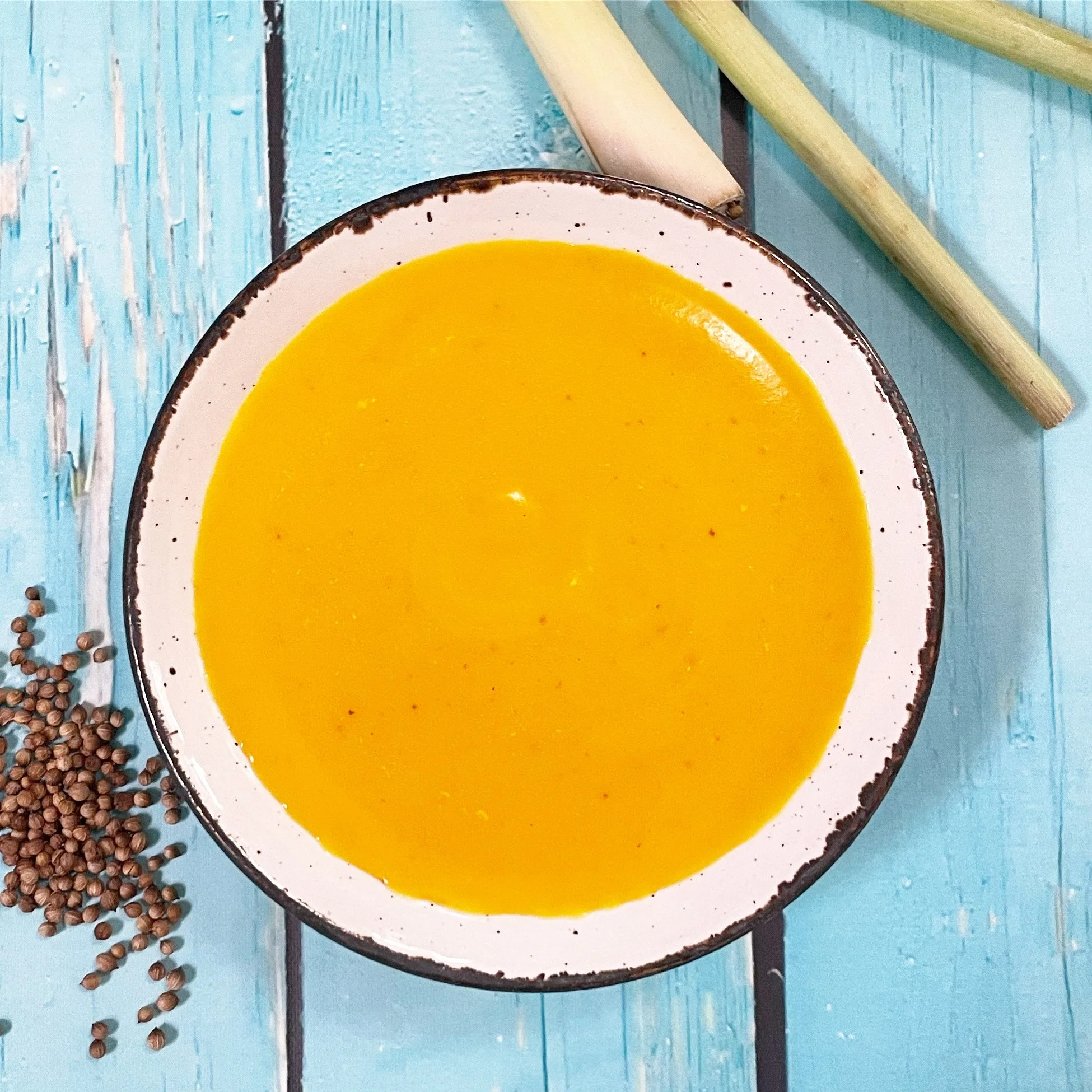 Creamy coconut lemongrass kabocha squash soup in a white bowl