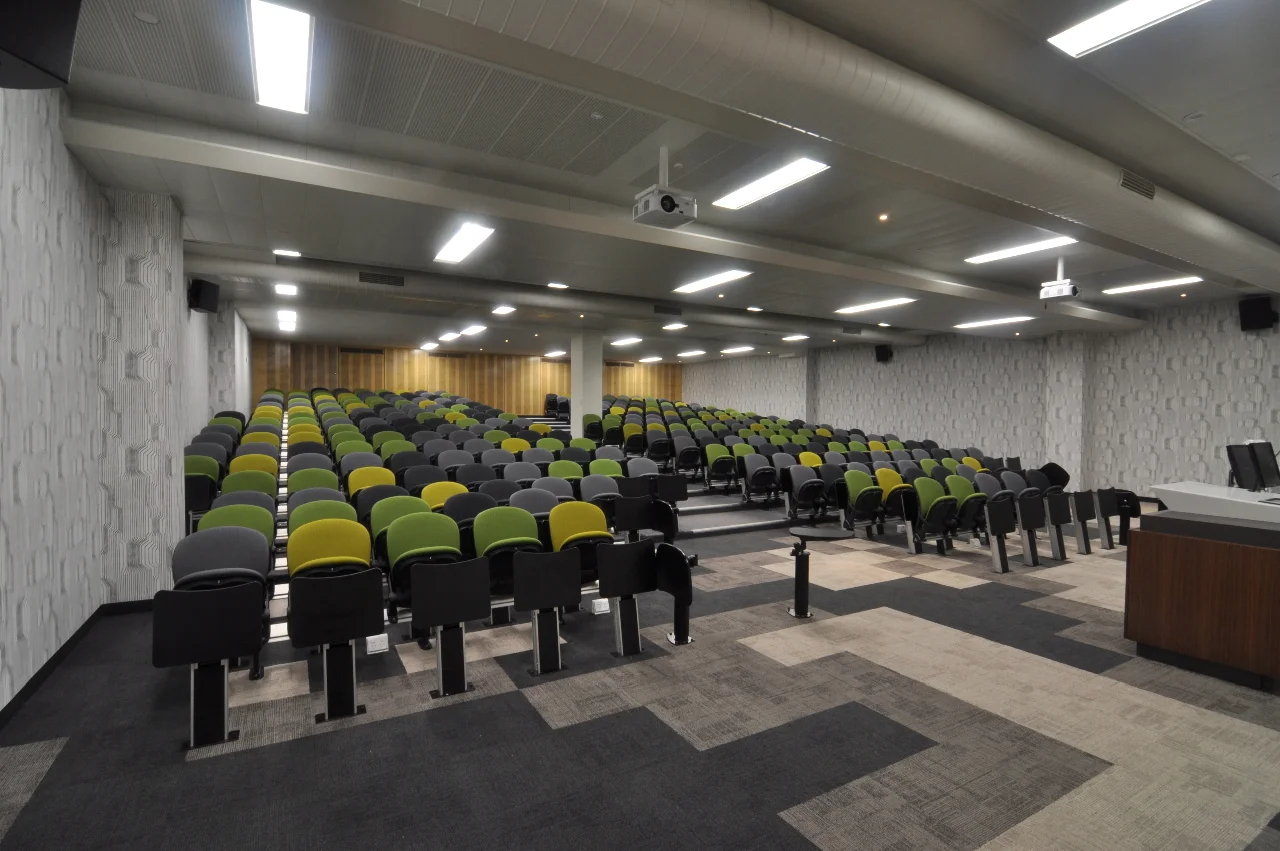 UniSA CEA | Lecture Theatre Redevelopment Services: BESTEC Contractor: Harrold & Kite Photographer: W+S Refurbishment of existing Lecture Theatre. Theatre specific colours and fabrics, acoustic timber panels, textured wall paper, bespoke lectern with integrated control of lighting, media and AV equipment.