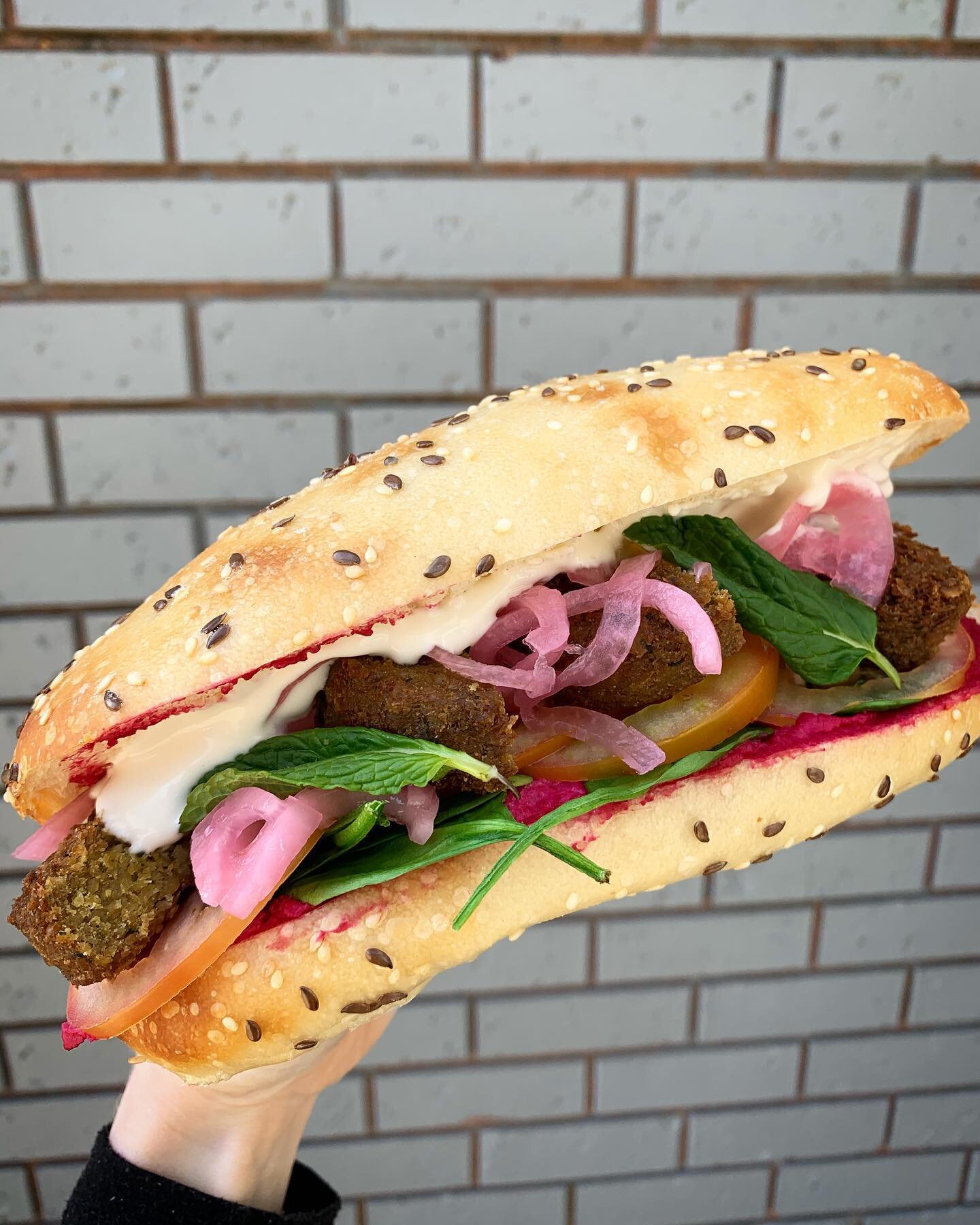 Raise your hand if you love falafels as much as we do 🙋&zwj;♀️🙋&zwj;♂️This sandwich  is out most popular of all the Turkish rolls... filled with house-made beetroot hummus, baby spinach, tomato, falafel , pickled onion &amp; mayo 😏 order via the @