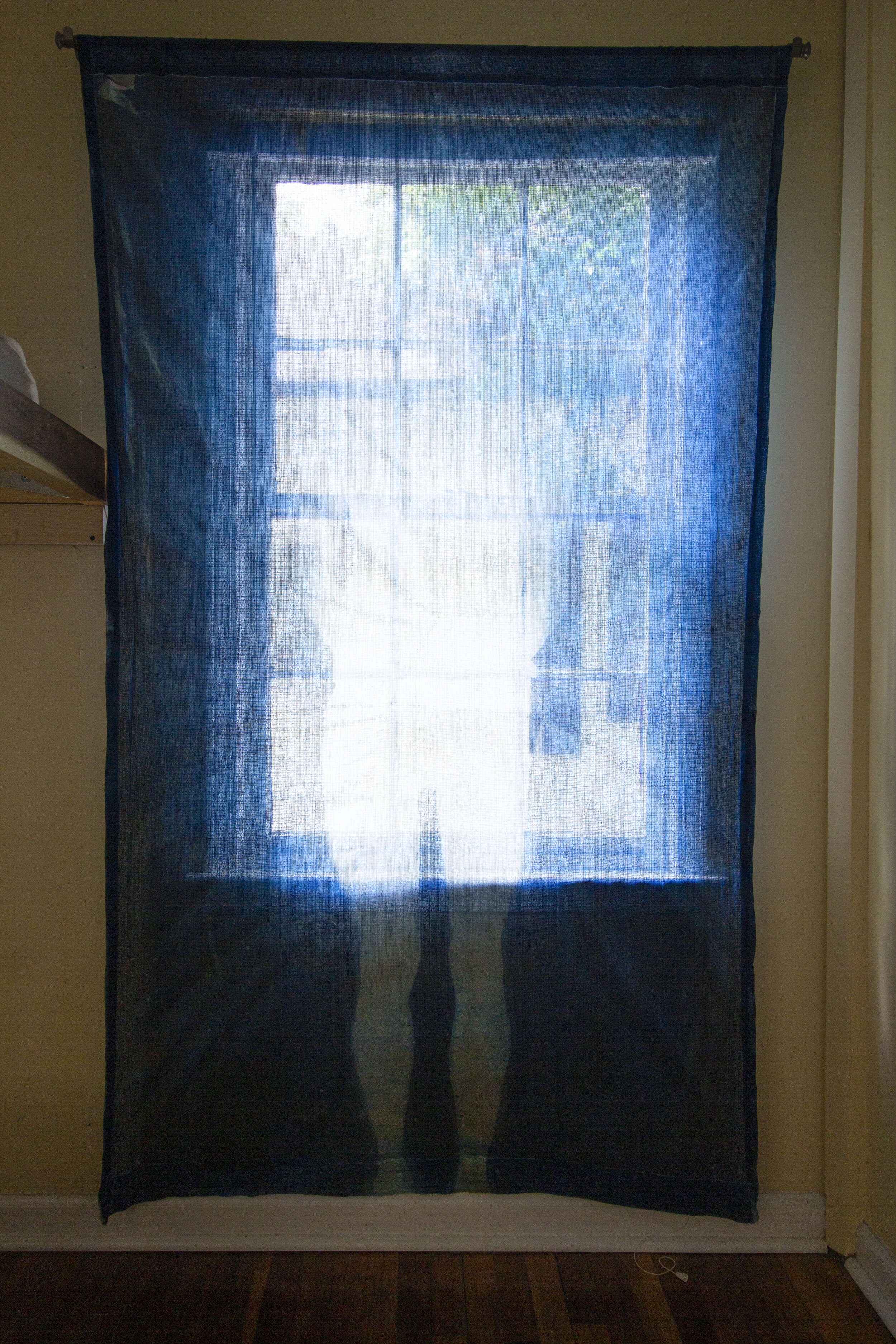 Fading [midday], 2020, cotton curtain, cyanotype solution, curtain rod, and hardware, 55 x 84 inches.