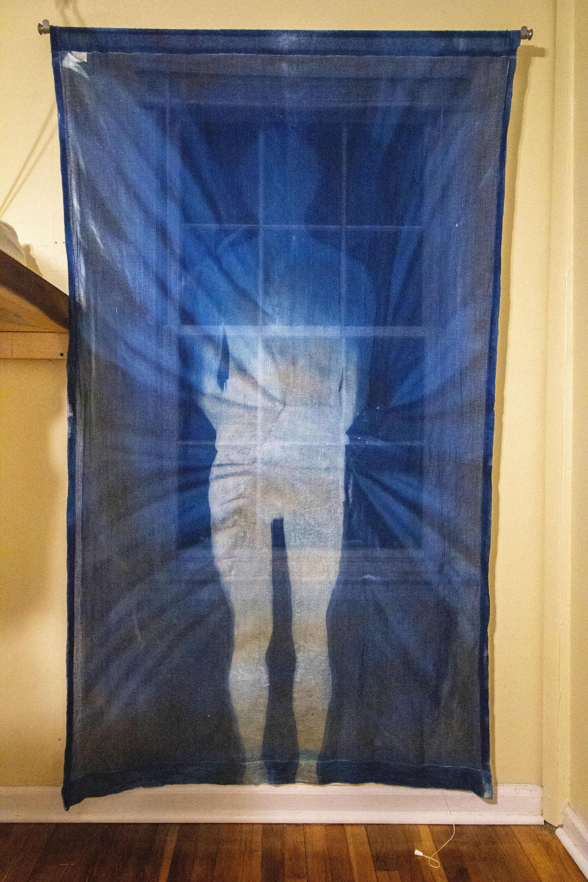 Fading [night], 2020, cotton curtain, cyanotype solution, curtain rod, and hardware, 55 x 84 inches.