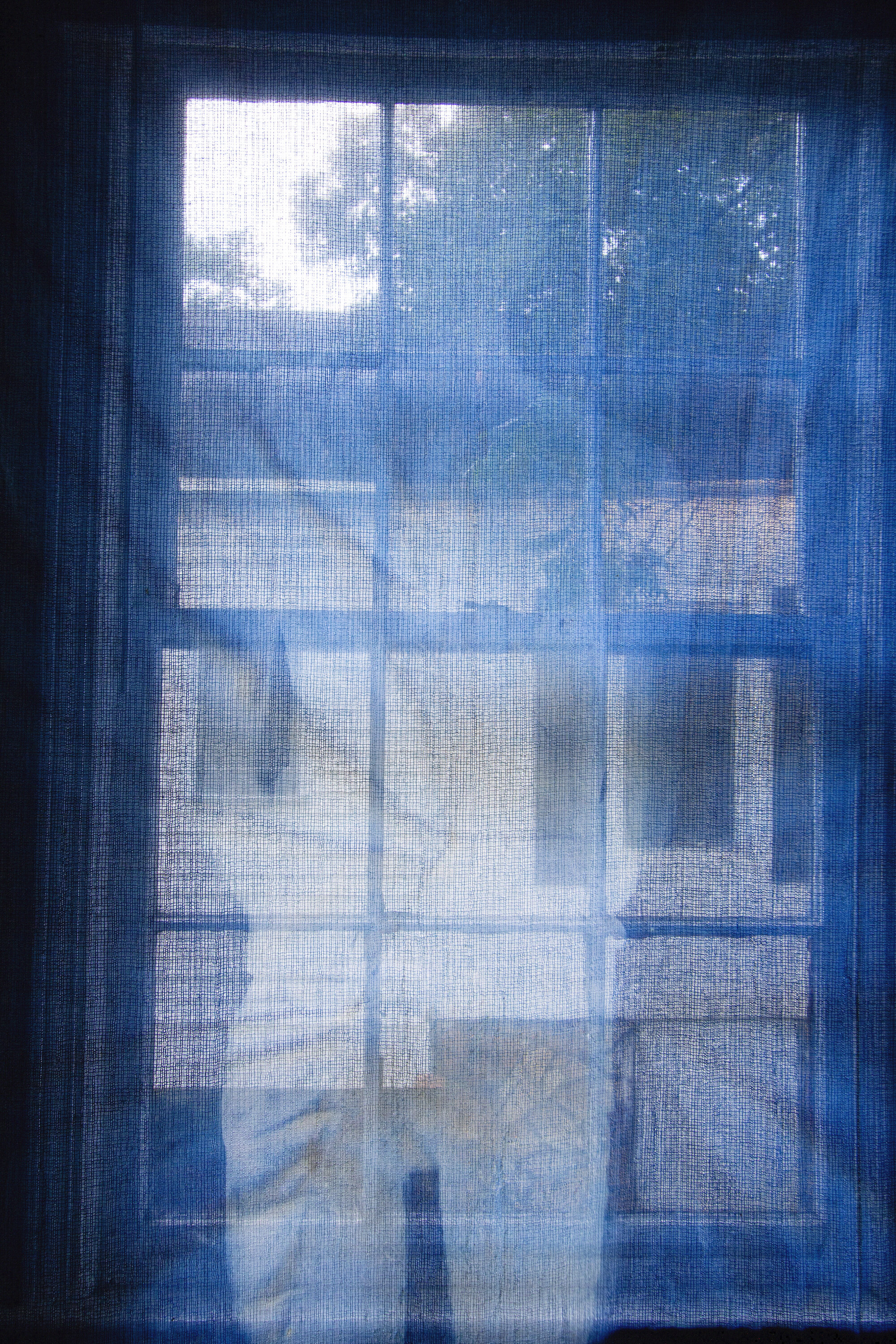 Fading (detail) [early evening], 2020, cotton curtain, cyanotype solution, curtain rod, and hardware, 55 x 84 inches.