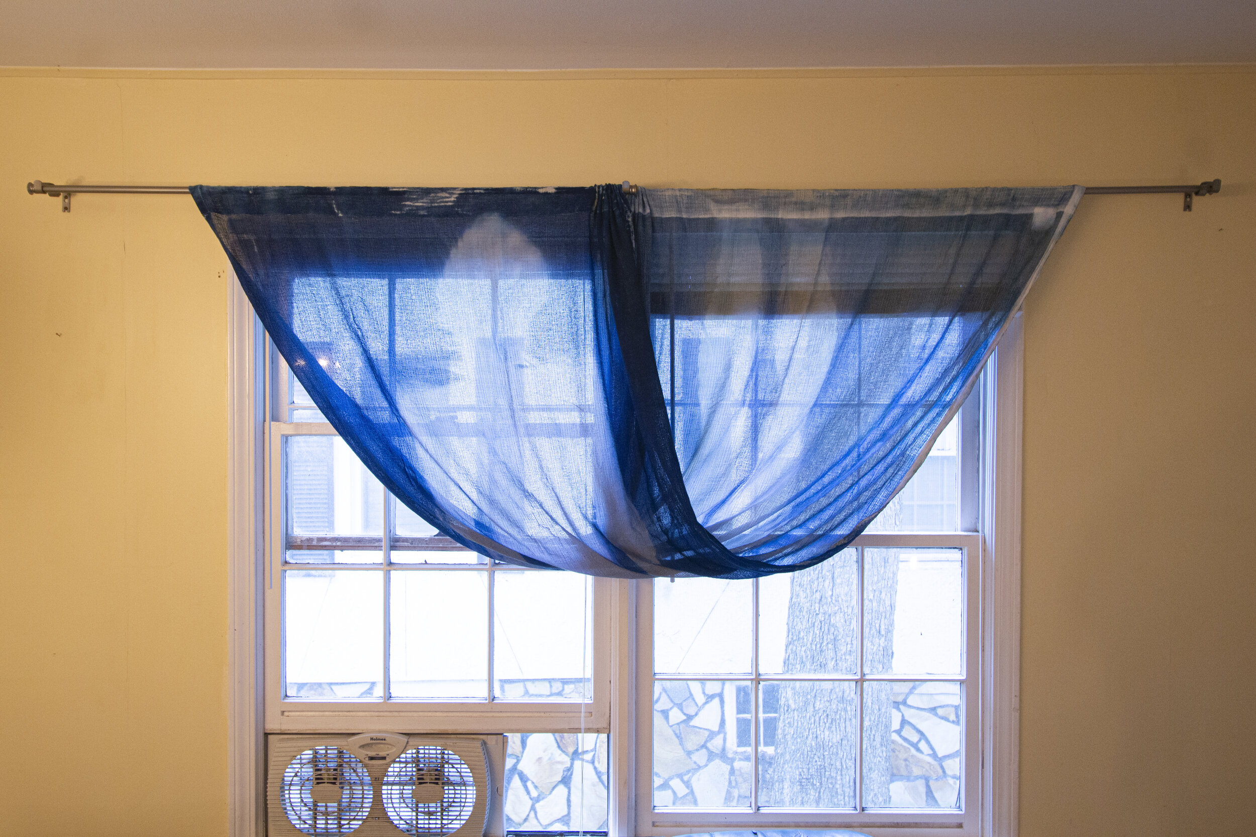 Half Twist [midafternoon], 2020, cotton curtain, cyanotype solution, curtain rod, and hardware, 110 x 42 inches