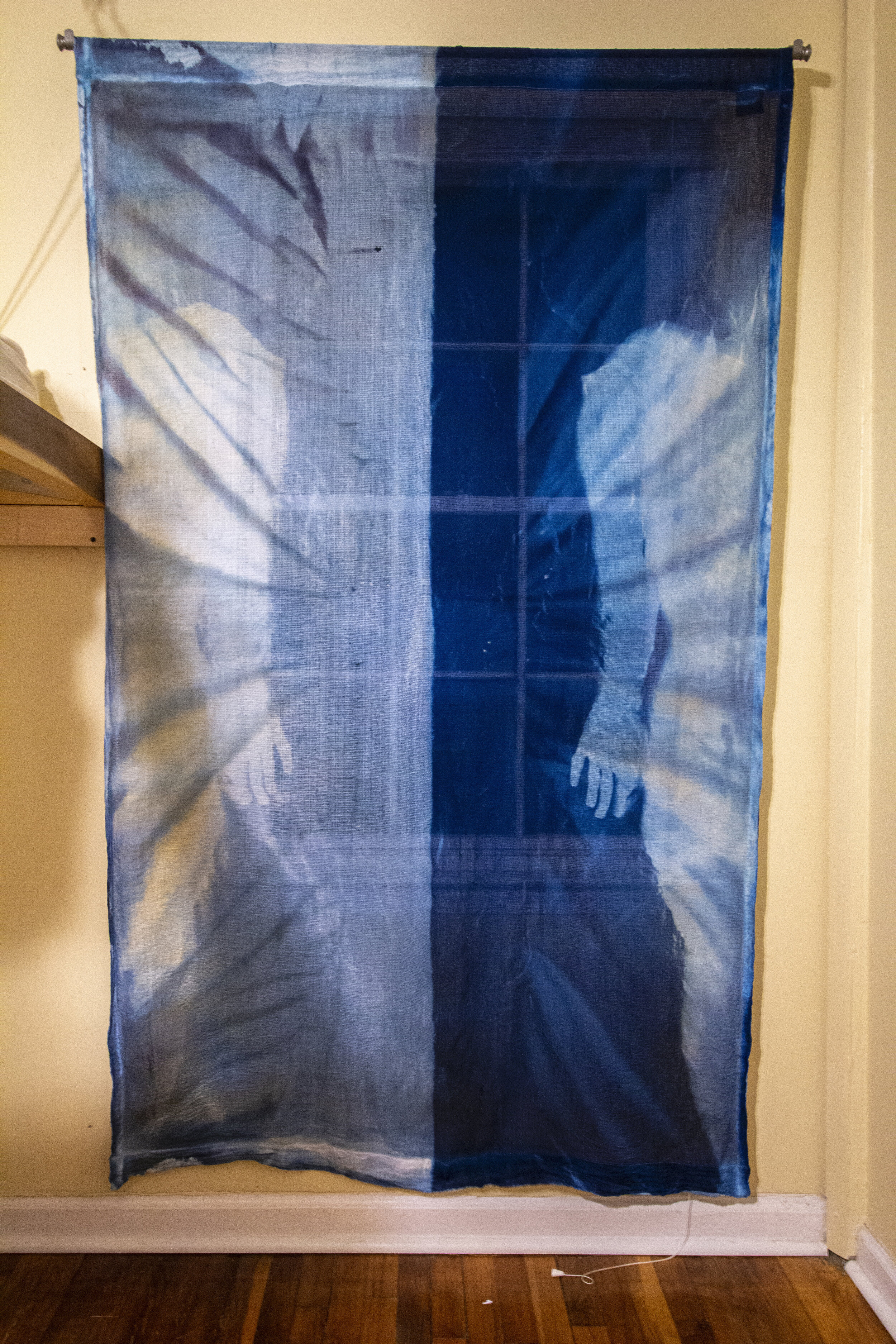 Mirror Image [night], 2020, cotton curtain, cyanotype solution, curtain rod, and hardware, 55 x 84 inches