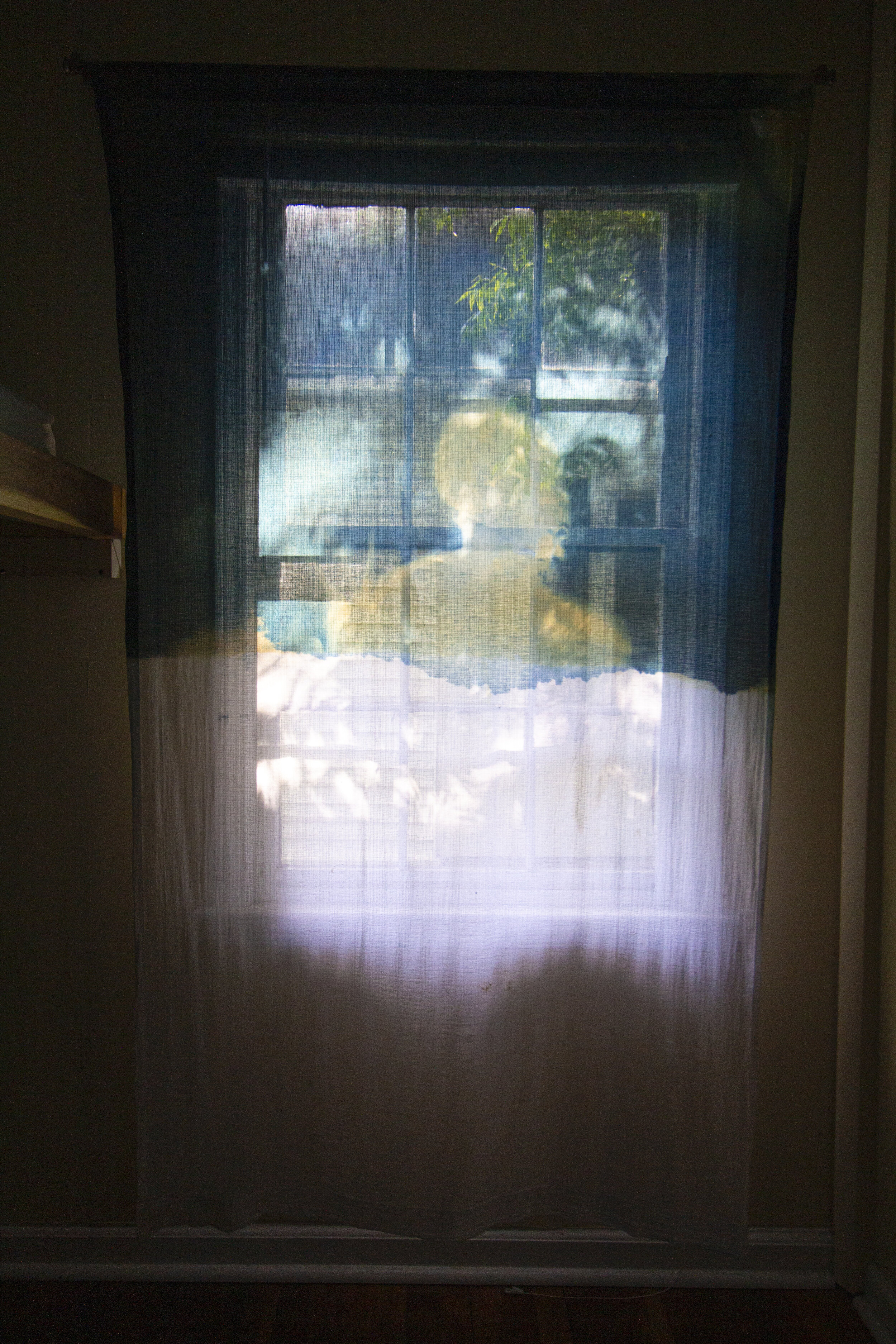 Sunrise [late afternoon], 2020, cotton curtain, cyanotype solution, curtain rod, and hardware, 55 x 84 inches