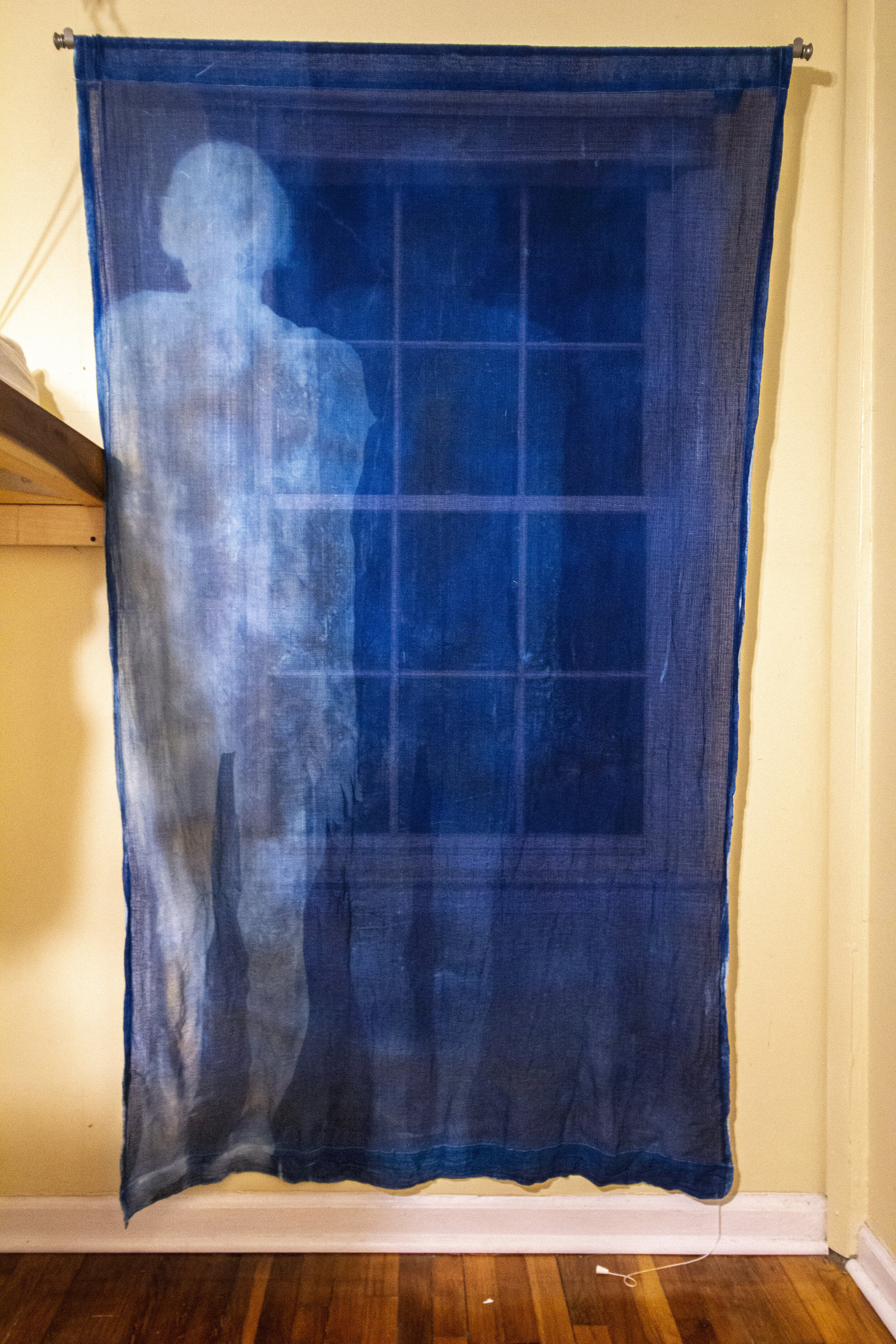 Unfolding [night], 2020, cotton curtain, cyanotype solution, curtain rod, and hardware, 55 x 84 inches