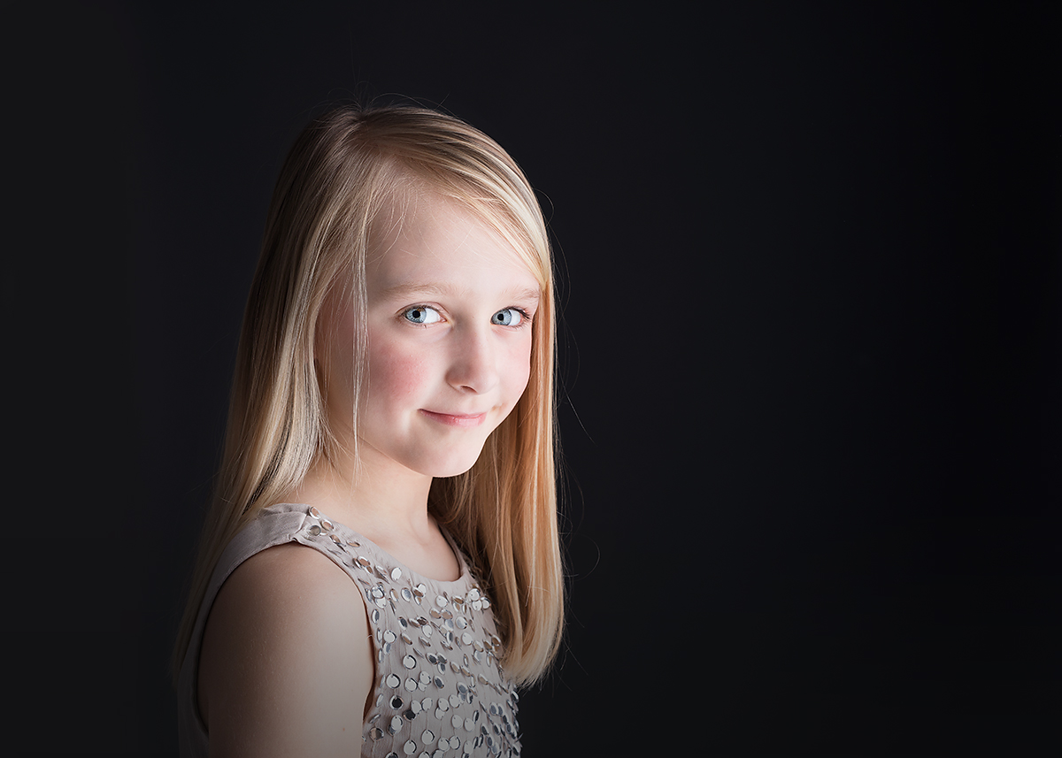 tween girl in studio on black background at candace hires photography