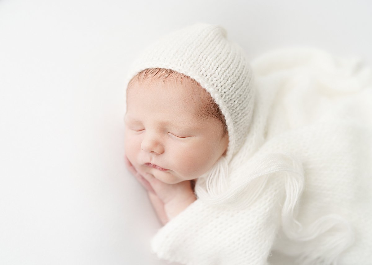beautiful newborn baby girl photographed all in white in st simons island