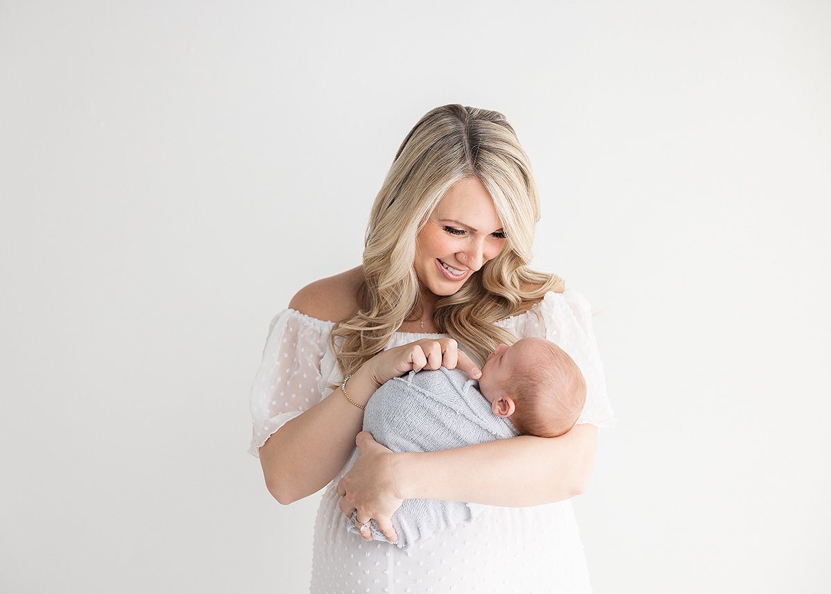 st simons island mom holding her newborn in her newborn portrait session