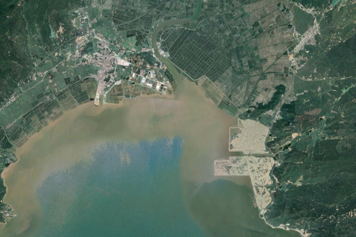 This aerial photo gives a sense of scale of the project we are reimagining as a new ecological coastline on the South China Sea in Taishan. The perimeter of the reclamation area (pictured right) is approximately 20 linear kilometers (12 linear miles) and will be the site of a new city in the future. The dark green grid pattern along the coastline to the North shows the fish farms and agricultural areas beyond. Our project will be a considerable improvement over what is typically a hard edged sea wall. The future can respond to sea level rise with biodiverse habitats and occupiable waterfronts. For many years China has been buying Hong Kong’s construction waste. Like Hong Kong, the vast majority of this waste has been used for land reclamation. China is a large country but it lacks arable farmland, therefore many of its new coastal cities are built on reclaimed land to preserve the hinterland for agriculture. In its new environmental push, China has now stopped buying Hong Kong’s construction waste and has put a moratorium on further reclamation projects. This reclamation site is all built from HK construction waste mixed with gravel and rock. If you look closely you can see evidence of this in tiles, rebar, etc. Hong Kong remains responsible for this waste to a degree and its interface with the ocean and coast.
