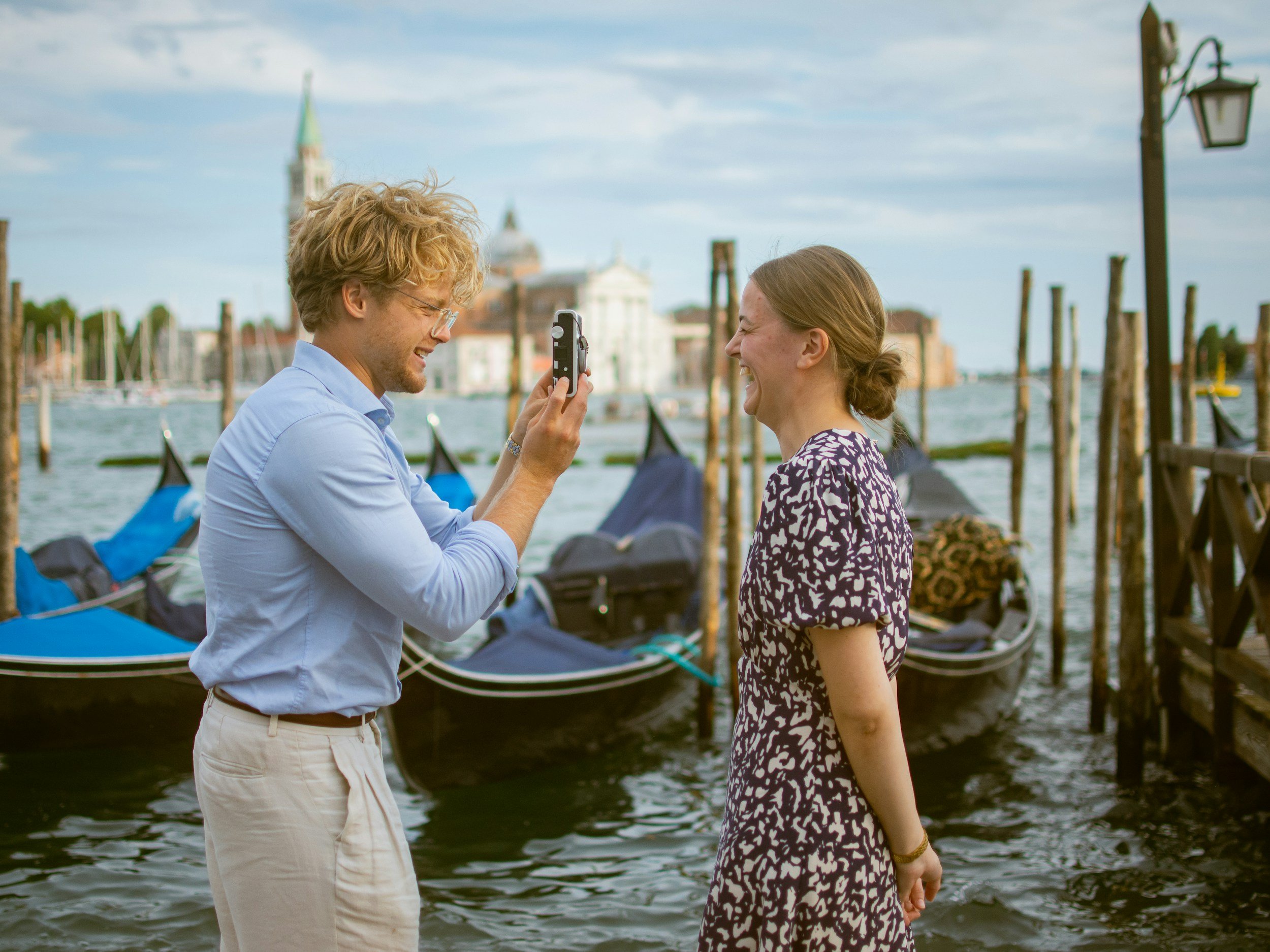 Honeymoon couple by the gondolas in Venice, Italy