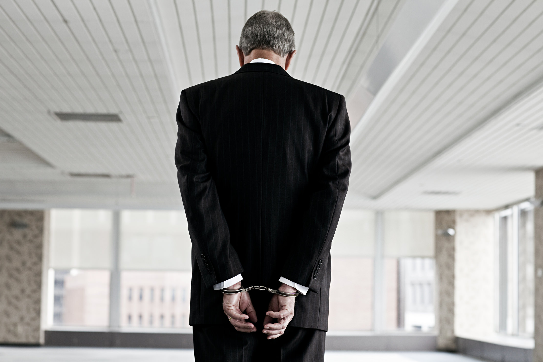 white collar exec handcuffs.jpeg