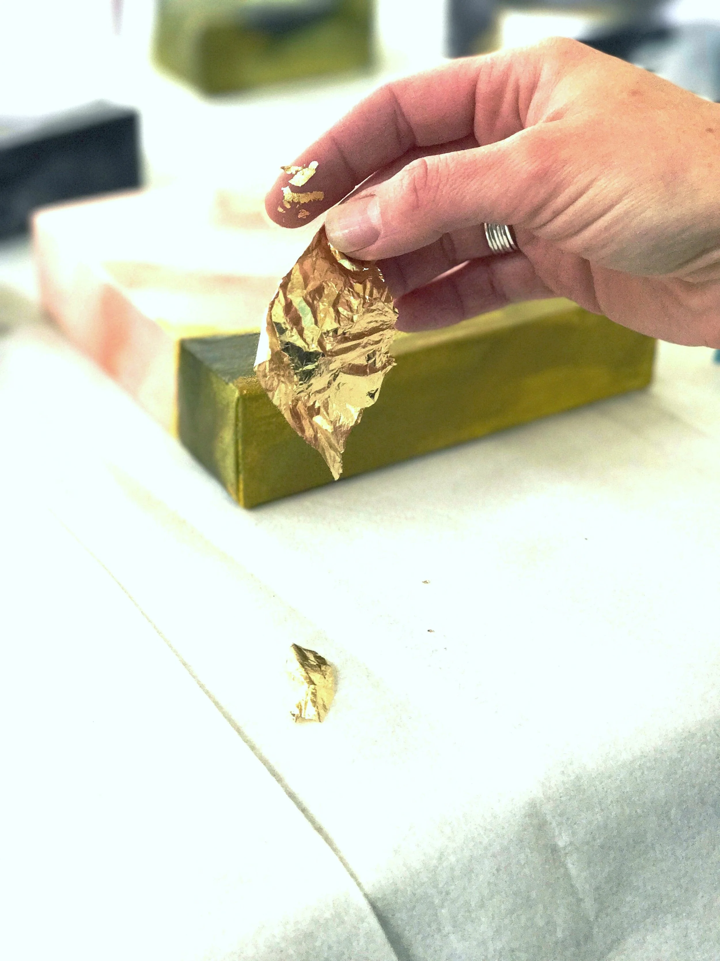 Applying Gold Leaf to a Painting 