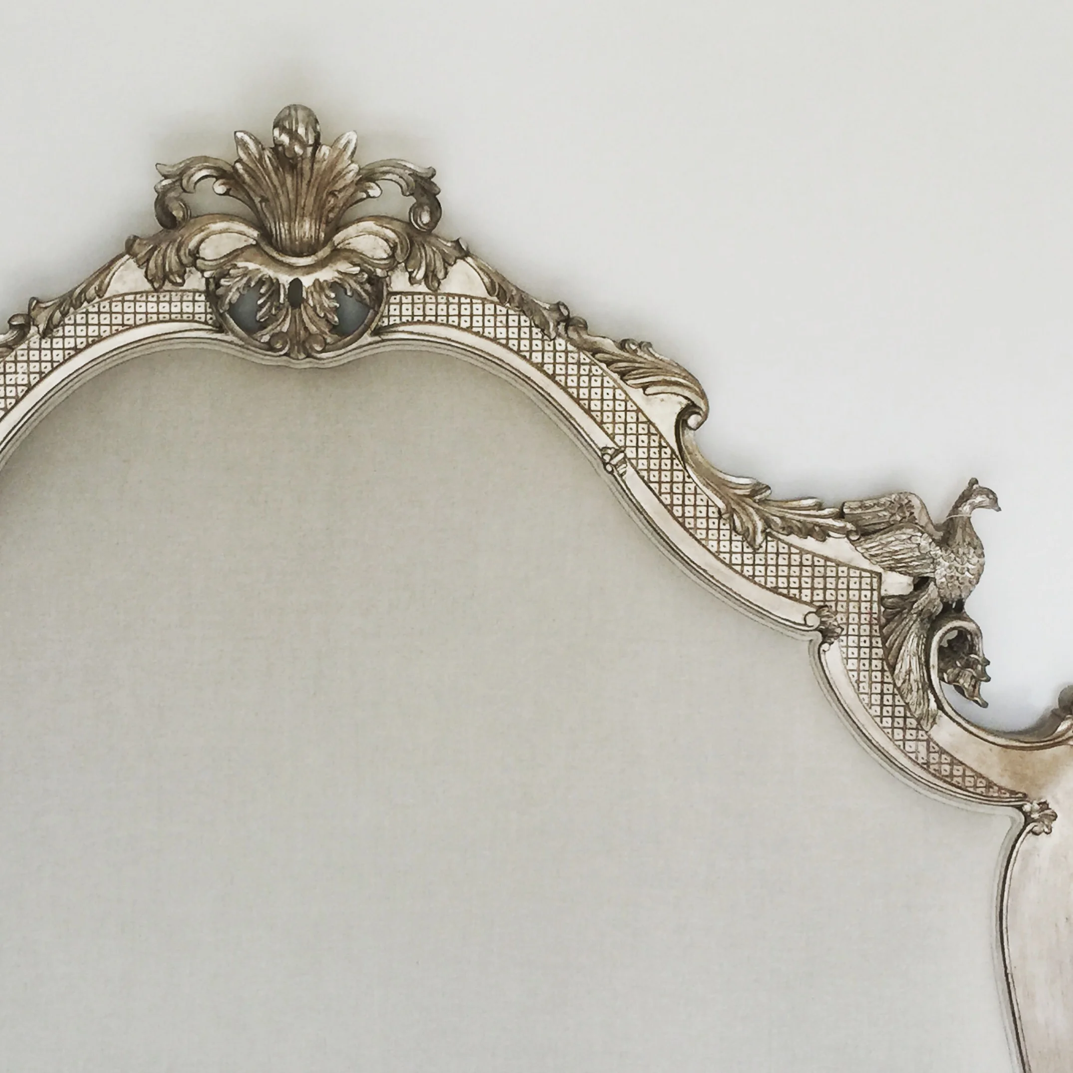 Headboard upholstered in neutral linen finished with double piping