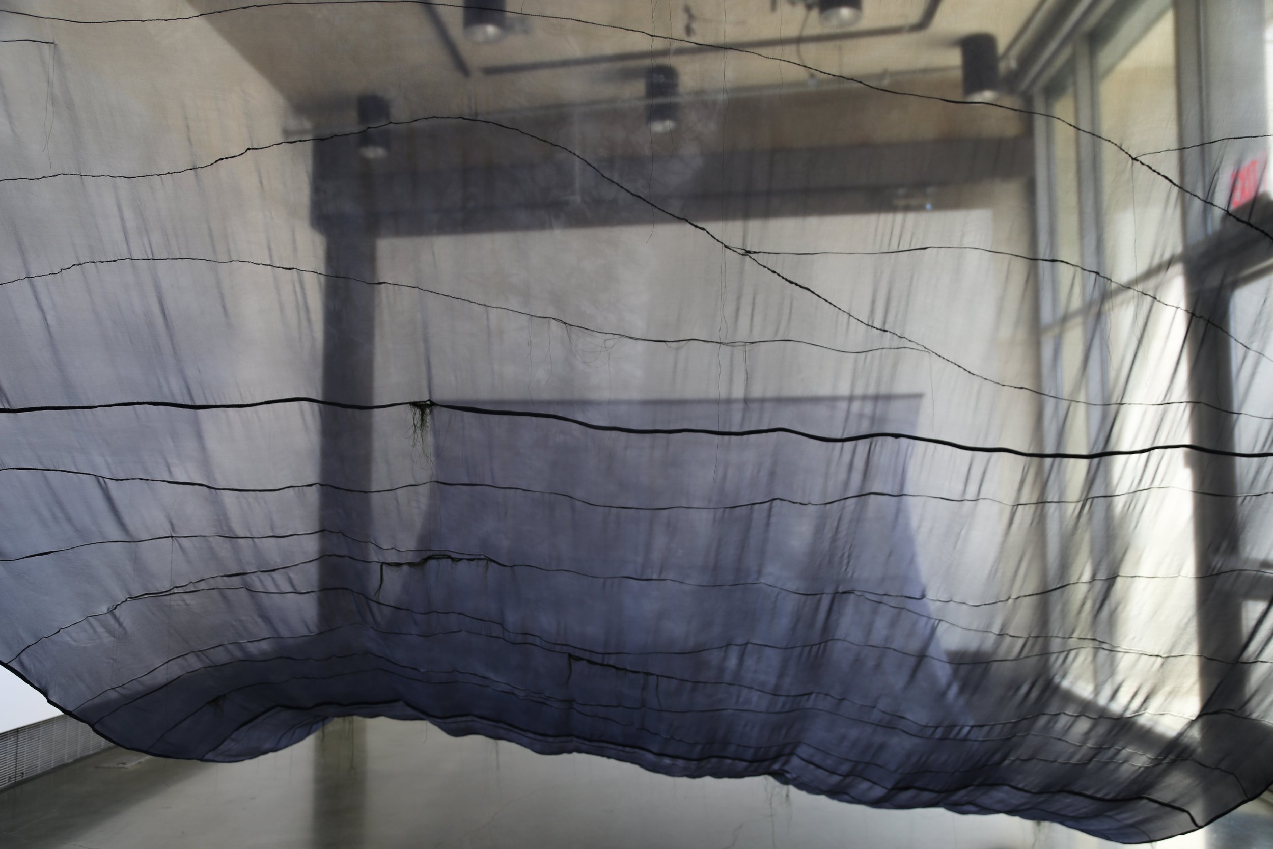  Undulations of Memory is an installation consisting of one large-scale textile sculpture, Wave. This work is time-based— it moves throughout the day in conjunction with a tidal chart. Wave  explores the artist’s relationship to nature, water, memory