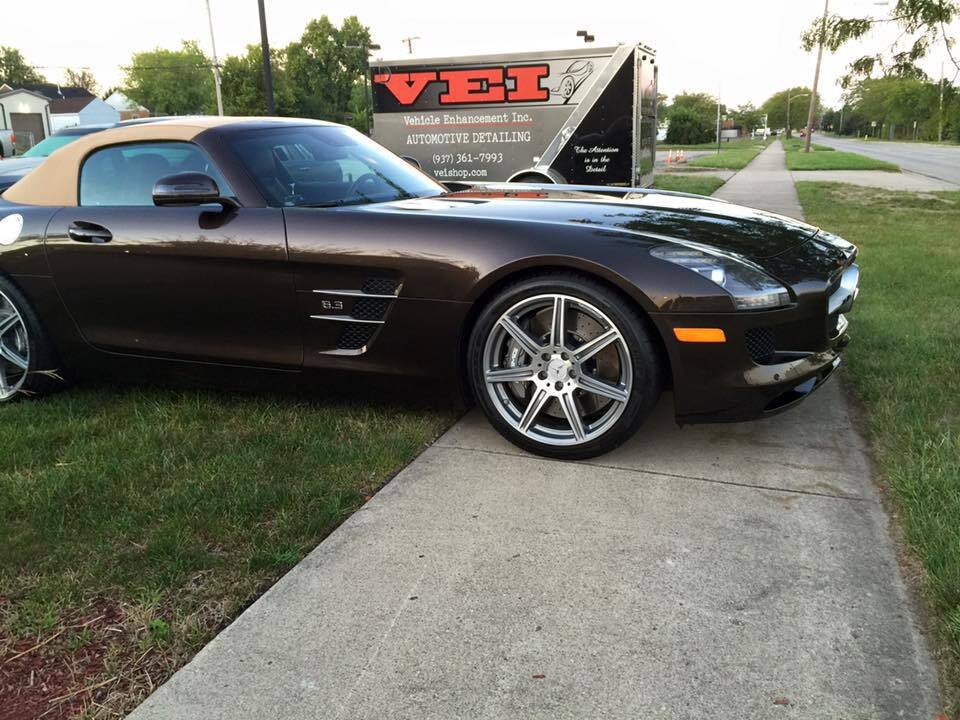 Clean car in front of VEI sign