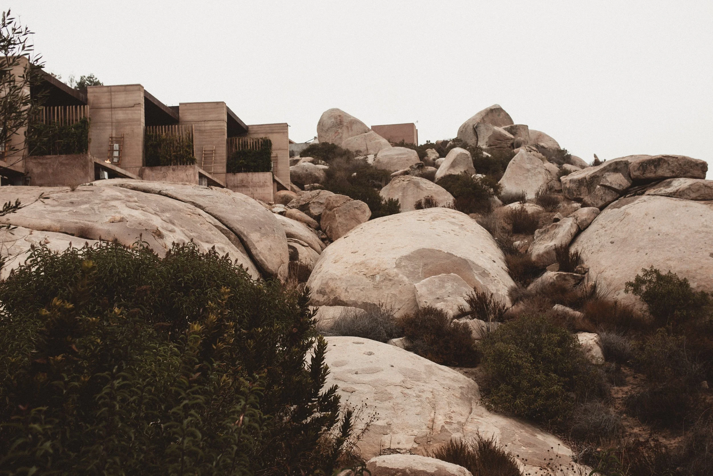 Piles of boulders with barely visible studios built into the hillside