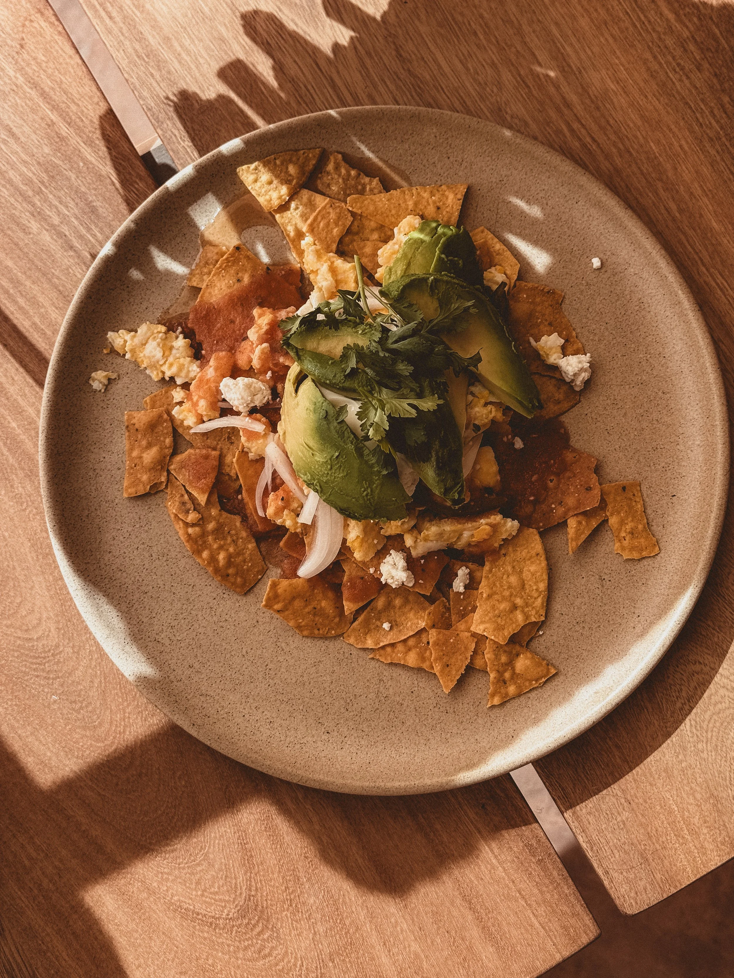 Plate of prepared chilaquiles with green salsa
