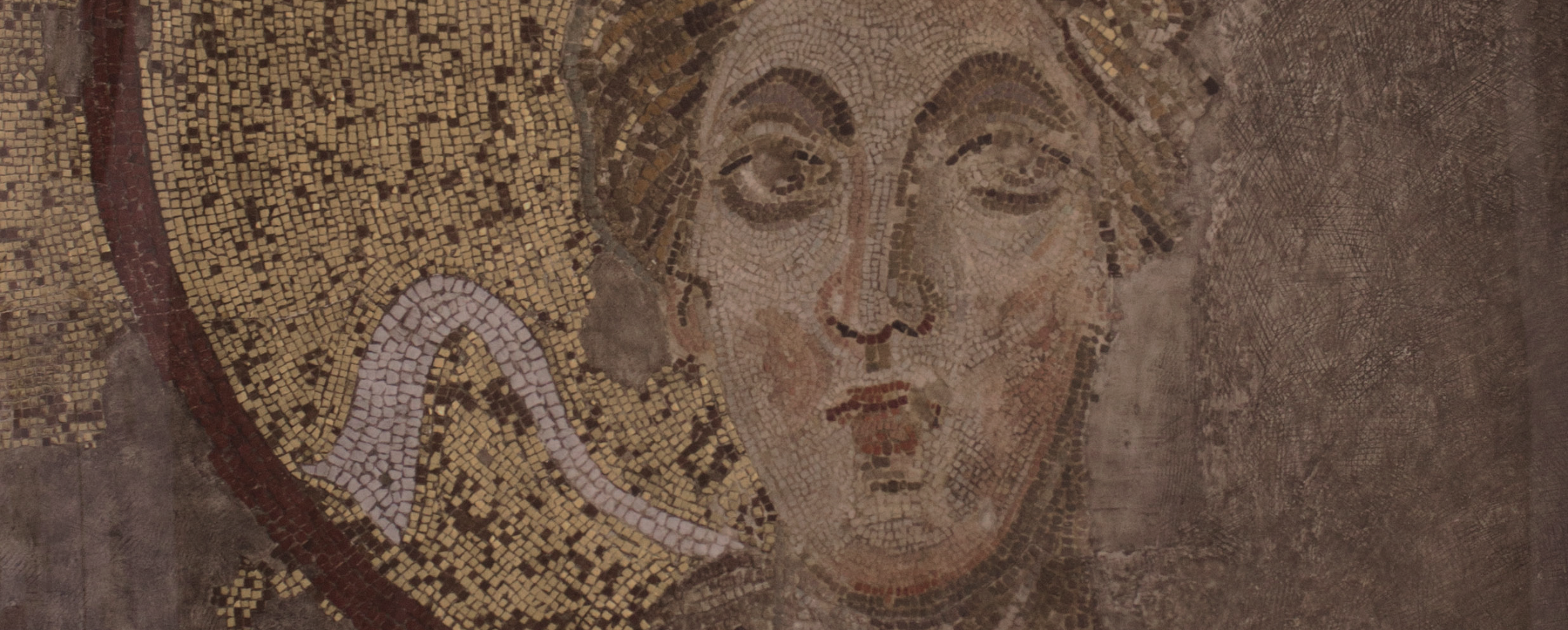 Golden mosaic of a woman partial destroyed