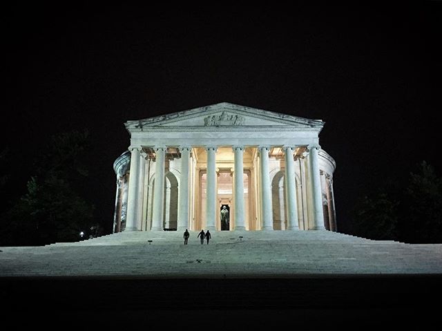 The night rests. The sky is empty, no clouds to catch the light. Buildings rise as beacons, all lit with memory. One raccoon has come up with the tide. A glint of fur against the blackness, he fiddles the leaves, unwary of history. Jefferson's Memorial is round, like the dome of the mind, so exalted. This stone rolled over tomb is not meant to shut ideas. The cold marble waits where a visitor might sit, only a little while, to press hands on old geometry. (TBT)
