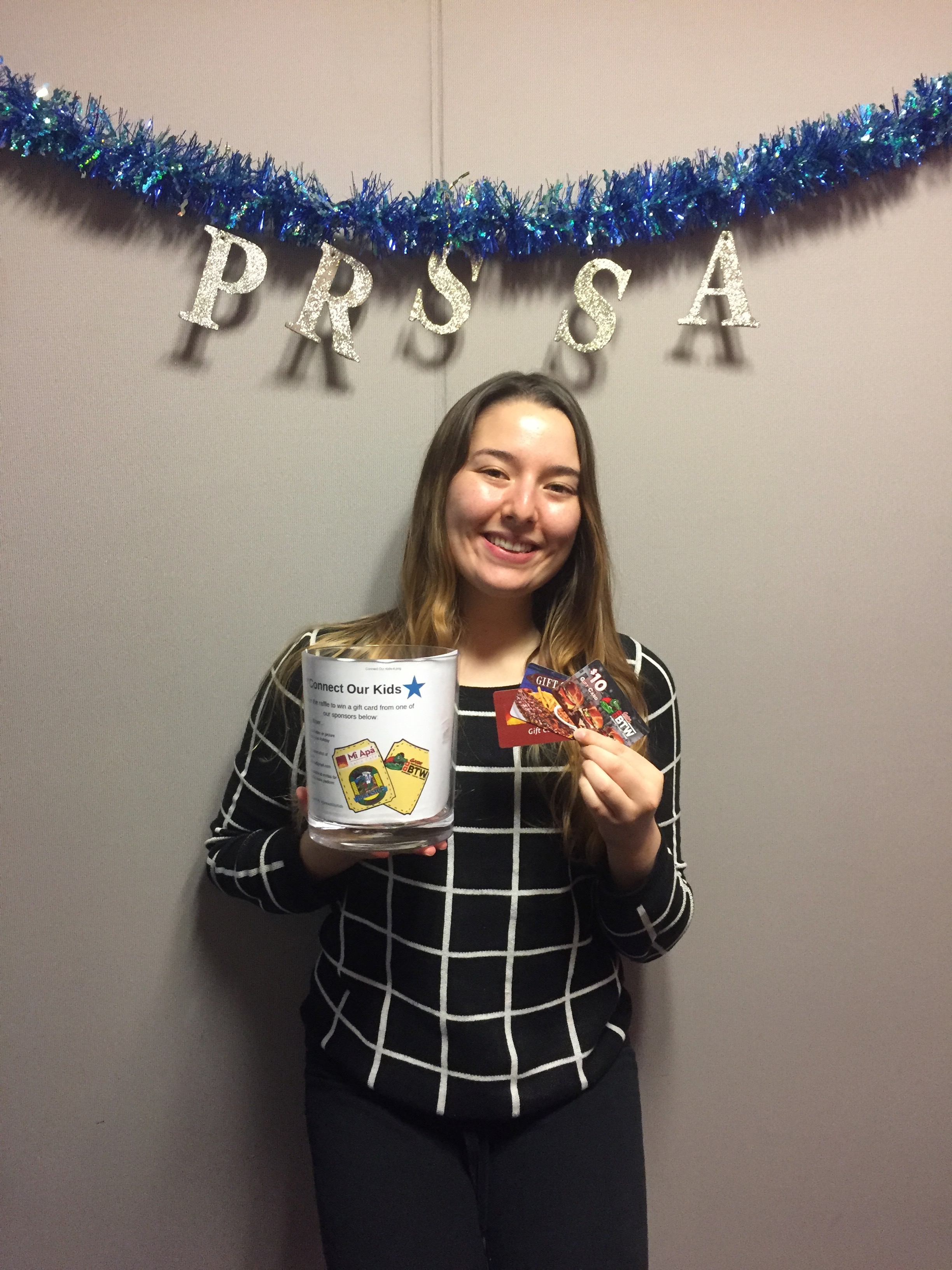 Andrea Mora, VP of Chapter Development, holding the raffle jar and gift cards