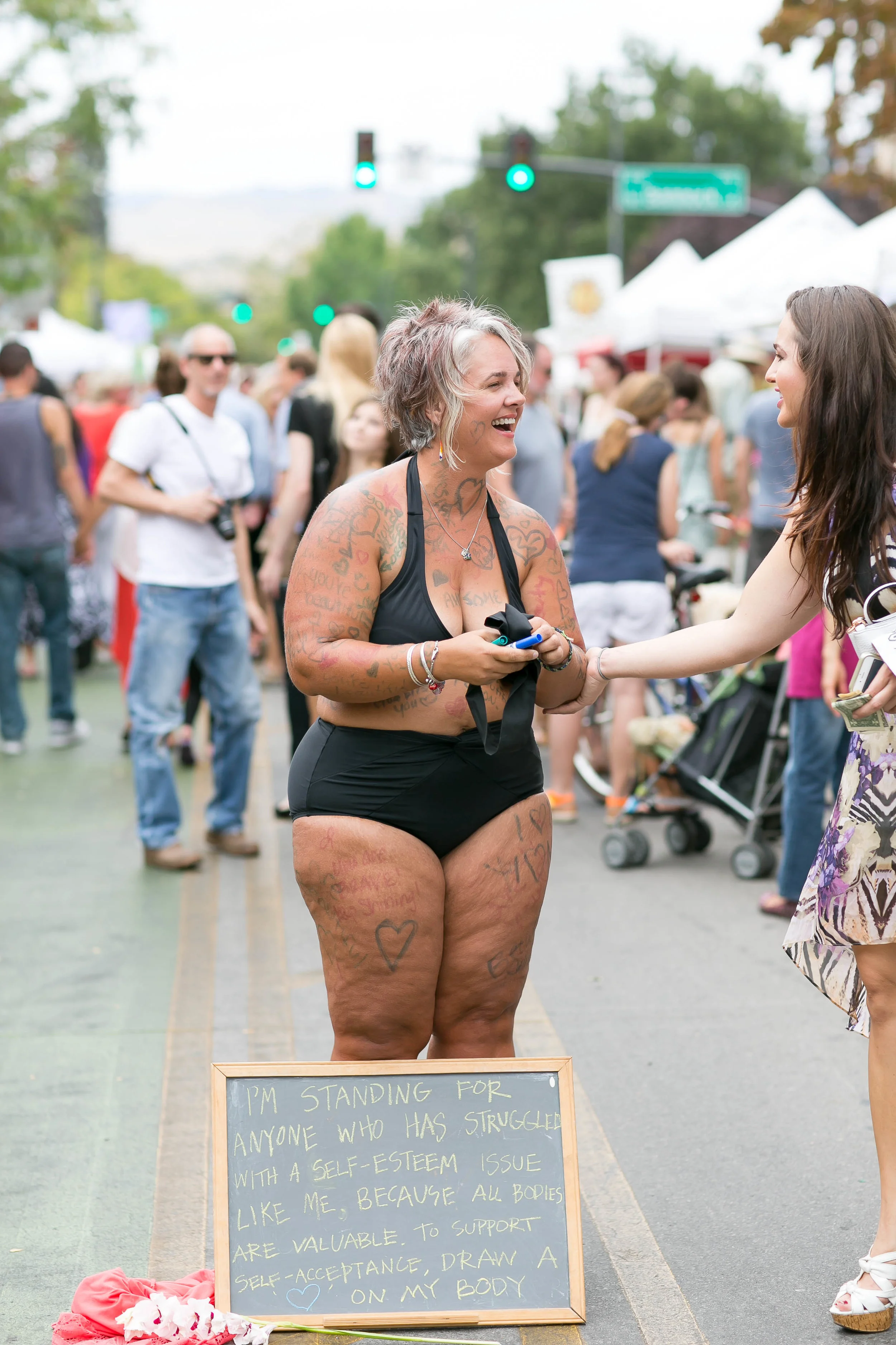 photo by Melanie Folwell of the stand for self-love , radical self-acceptance performance art activism piece, August 2015