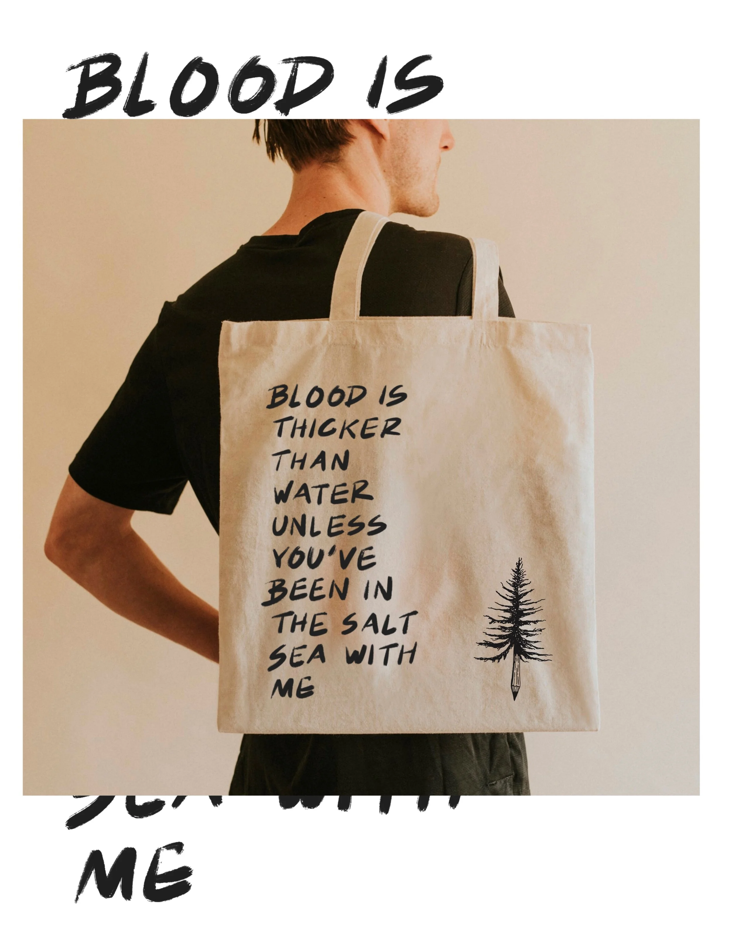 A person holding a tote bag with the quote "Blood is thicker than water unless you've been in the salt sea with me" and a small drawing of a tree.